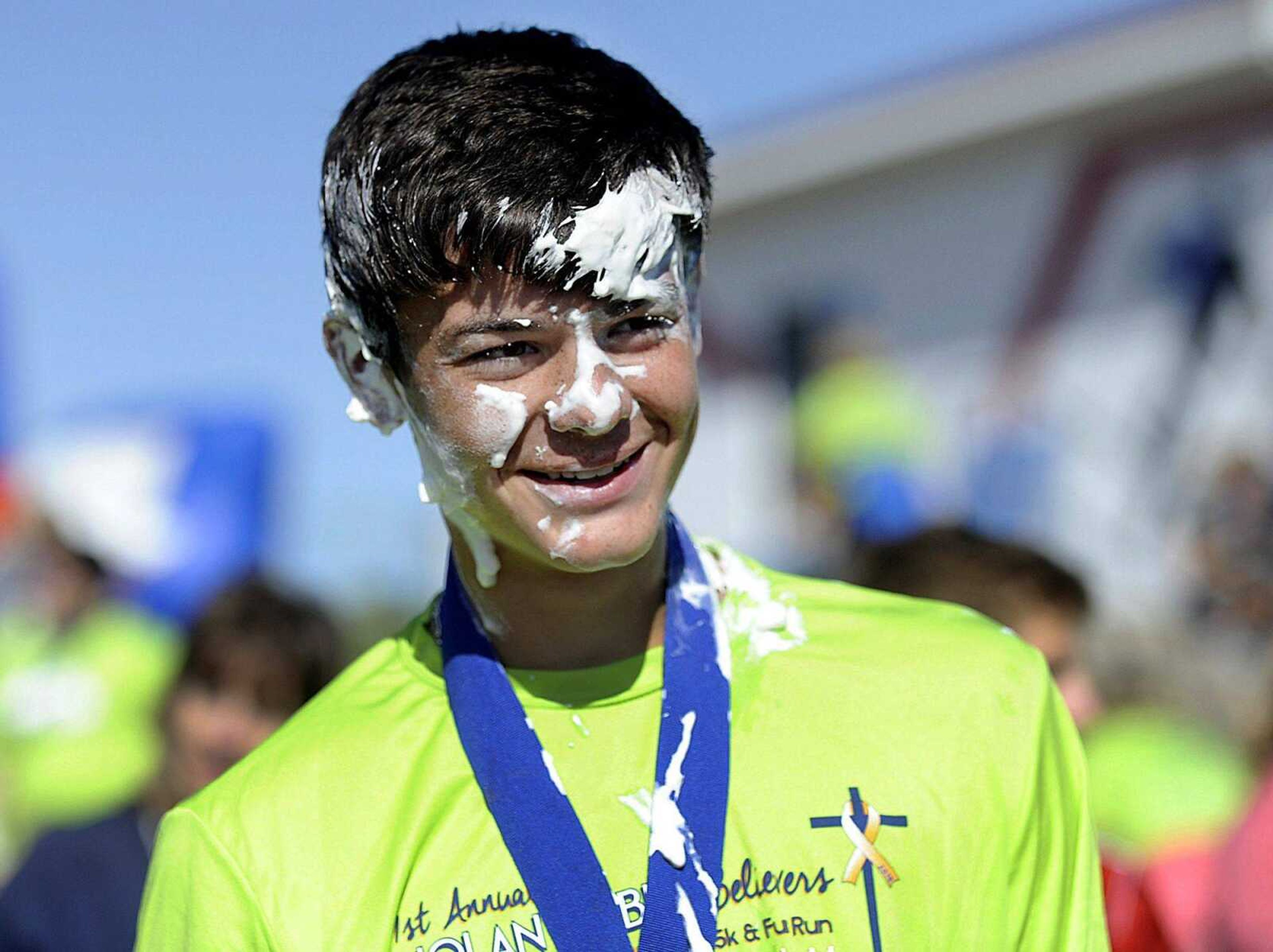 Colten Weber stands covered in whipped cream after completing the 5k in his brother's honor, the Nolan Weber Believers 5k and Fun Run in Jackson, on Sept. 13. Participants could donate money to childhood cancer and receive a plate full of whipped cream to plant on someone. (GLENN LANDBERG)