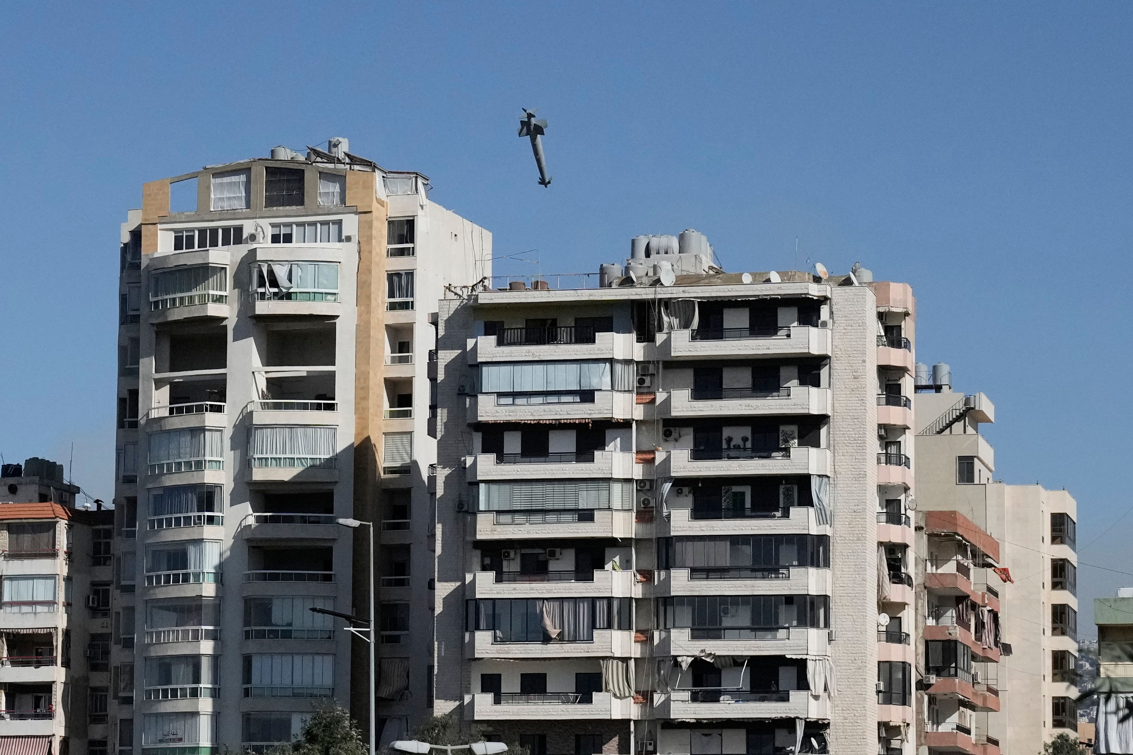 A bomb dropped from an Israeli jet heads towards a building in Ghobeiri, Beirut, Lebanon, Tuesday, Oct. 22, 2024. (AP Photo/Bilal Hussein)