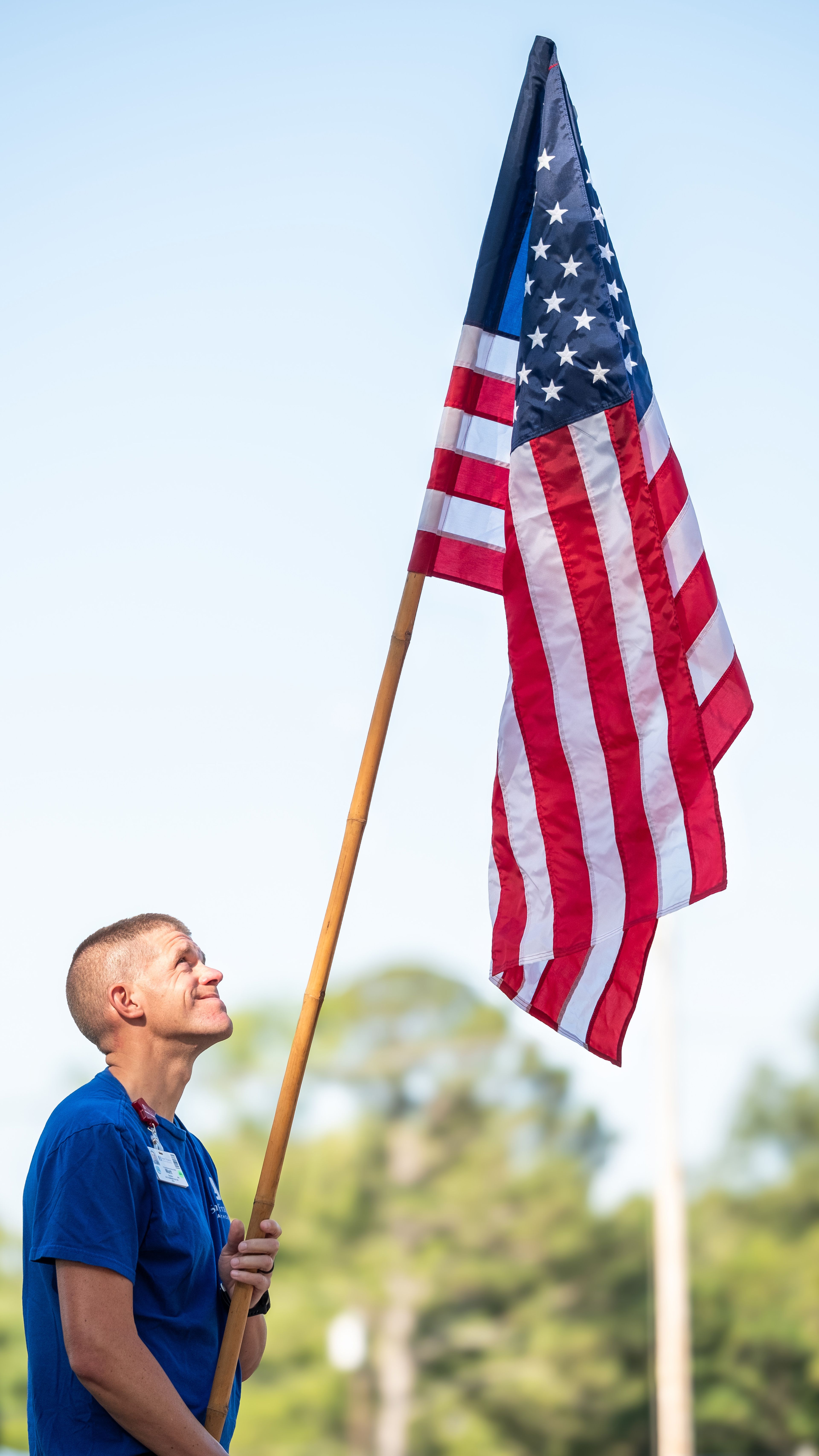 Matt Awasko of Cape Girardeau, representing Saint Francis Medical Center, holds the American flag to signal the start of the race.
