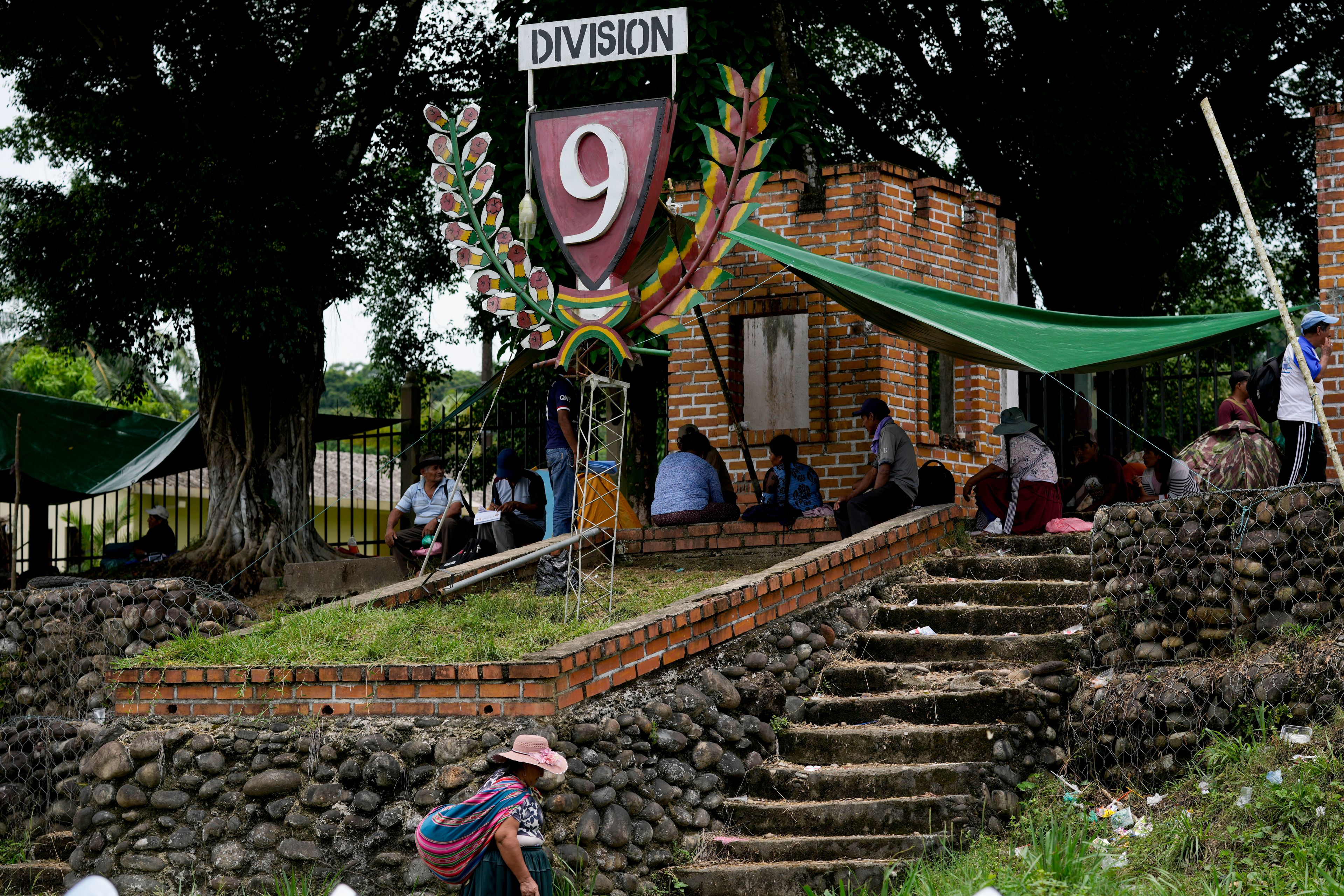 Followers of former President Evo Morales hold a vigil outside military barracks in Shinahota, Chapare region, Bolivia, Sunday, Nov. 3, 2024, amid an ongoing political conflict with the government of President Luis Arce. (AP Photo/Juan Karita)