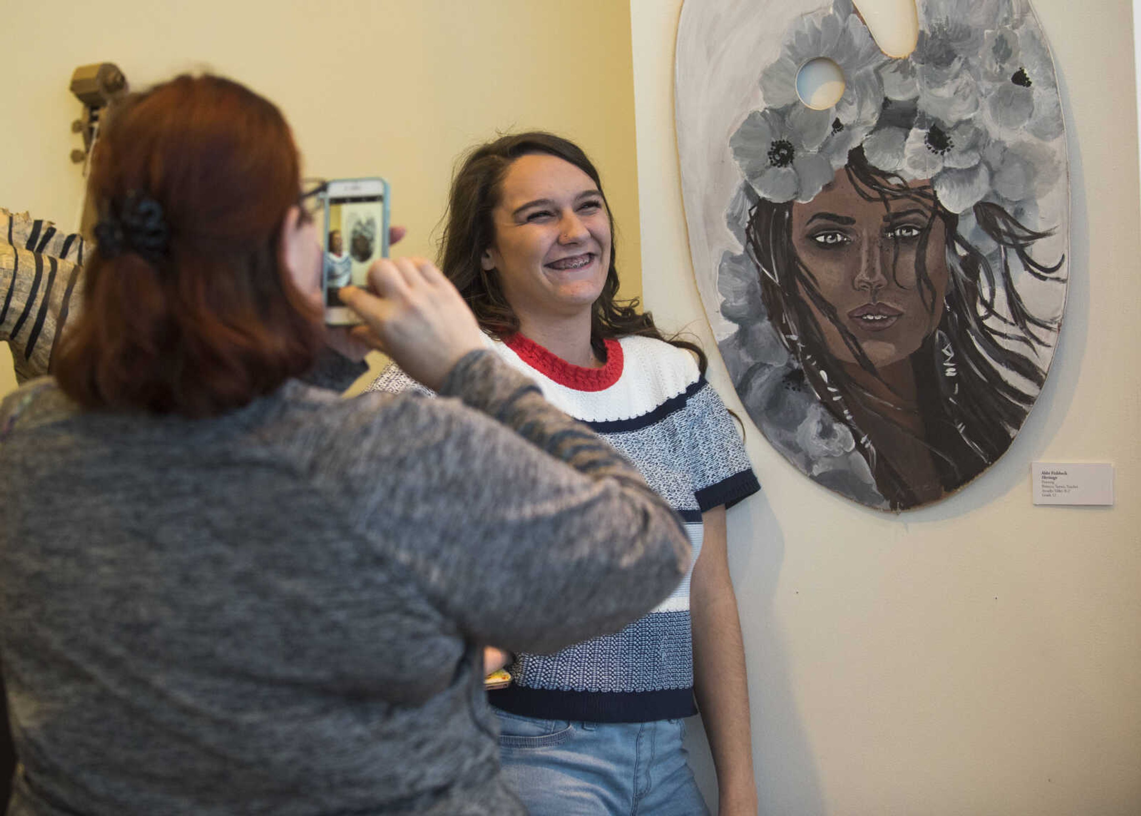 Arcadia Valley student Abbi Fishbeck stands next to her painting "Heritage" during a high school art exhibition Sunday, Feb. 18, 2018, at Crisp Museum in Cape Girardeau.