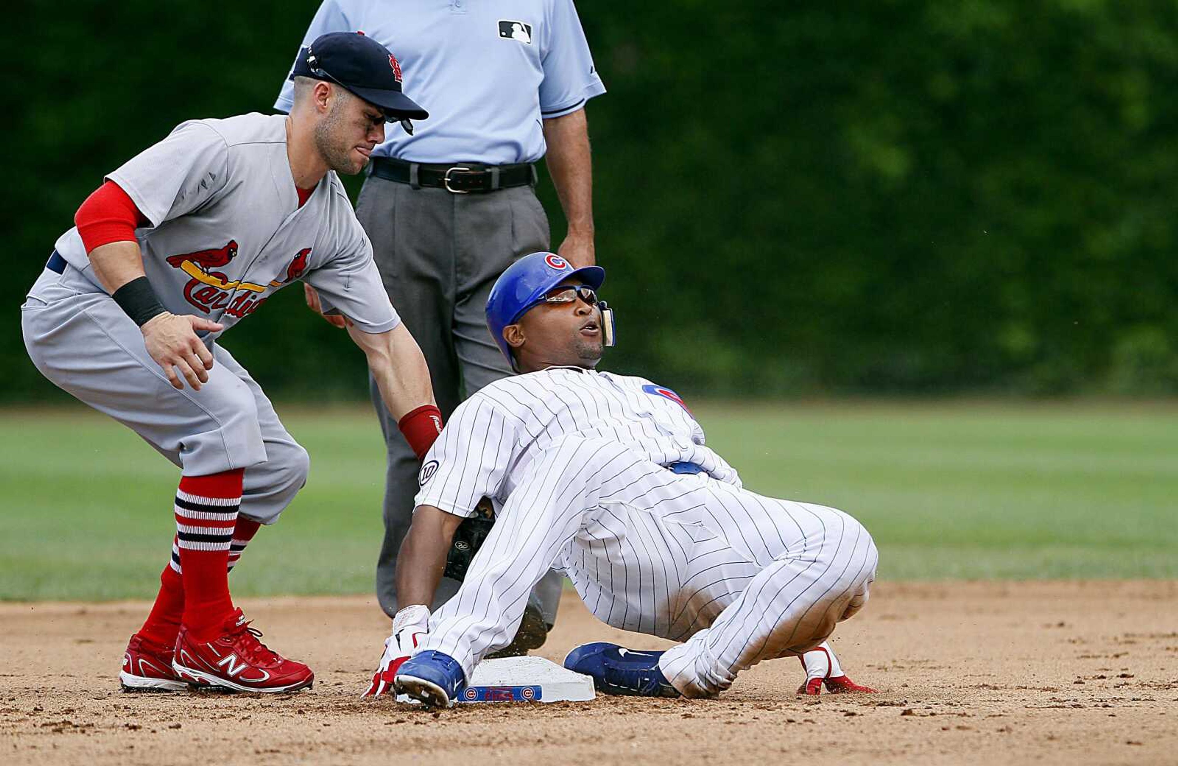 Cardinals second baseman Skip Schumaker applies a late tag as the Cubs' Marlon Byrd slides into second base with a double during the fourth inning Saturday in Chicago.<br><b>Charles Cherney<br></b>Associated Press