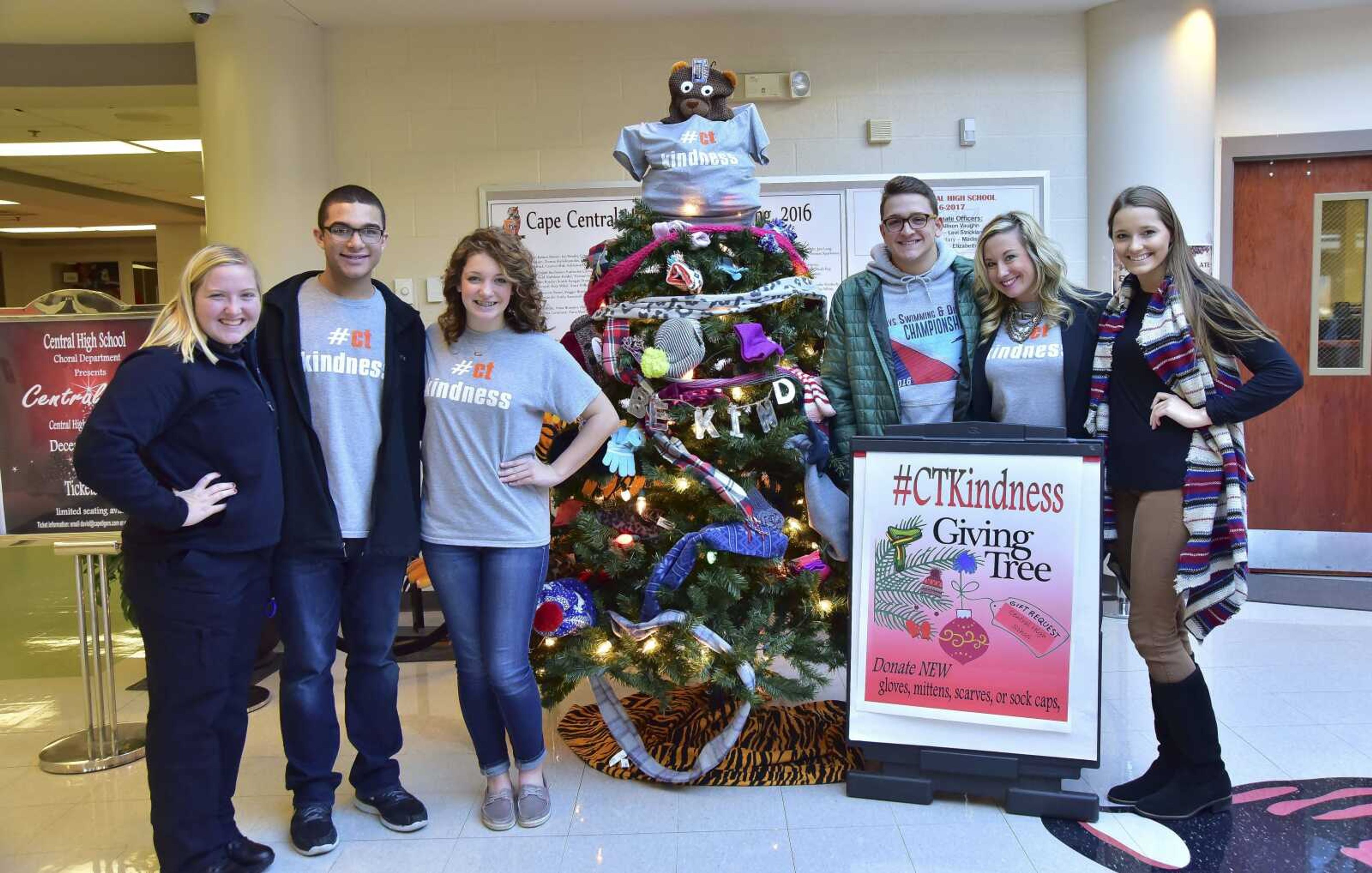 From left, Allison Vaughn, Isaiah Sterling, Logan Perry, Brogan Davis, assistant principal Leigh Ragsdale and Paeton Outman pose for a photo in front of the Giving Tree.