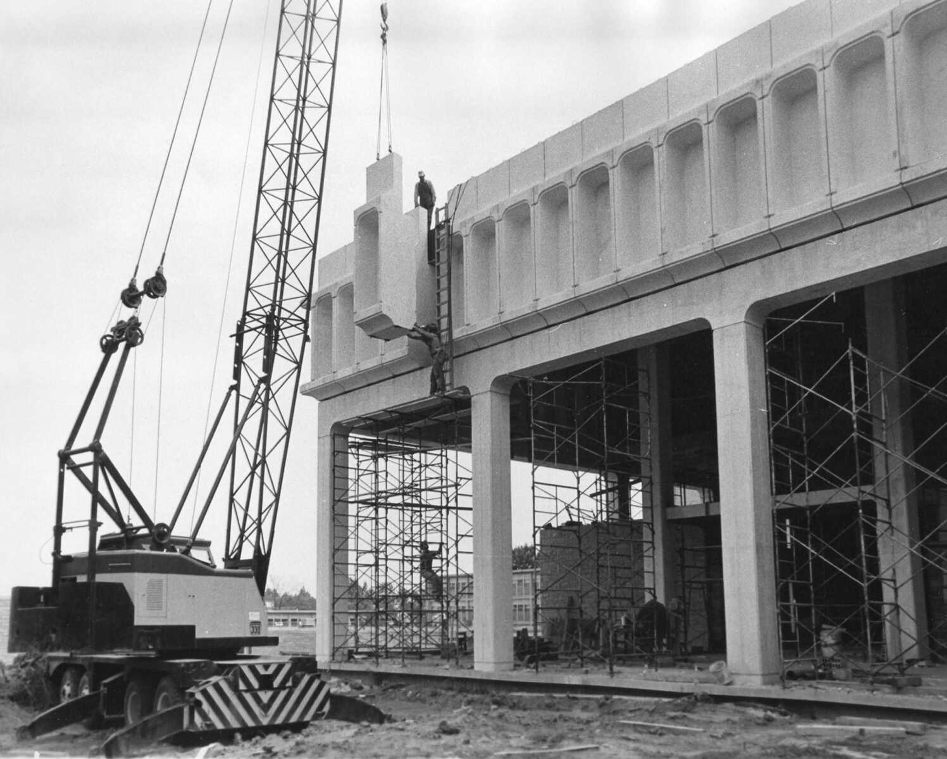 This unpublished photo shows the last of the pre-cast concrete pieces being put into place in the facade of the expanded Kent Library on July 15, 1967. (Southeast Missourian archive photo)