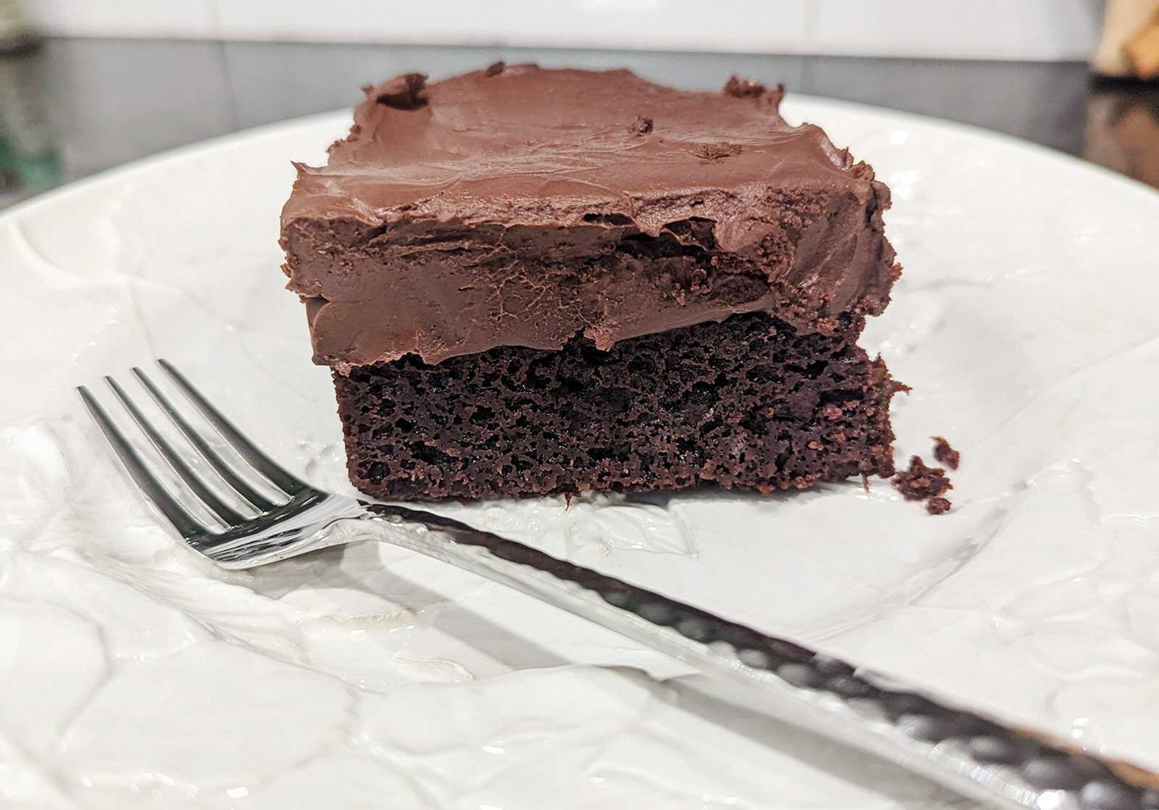 A slice of chocolate sheet cake lathered with namelaka proves there's no such thing as too much chocolate.