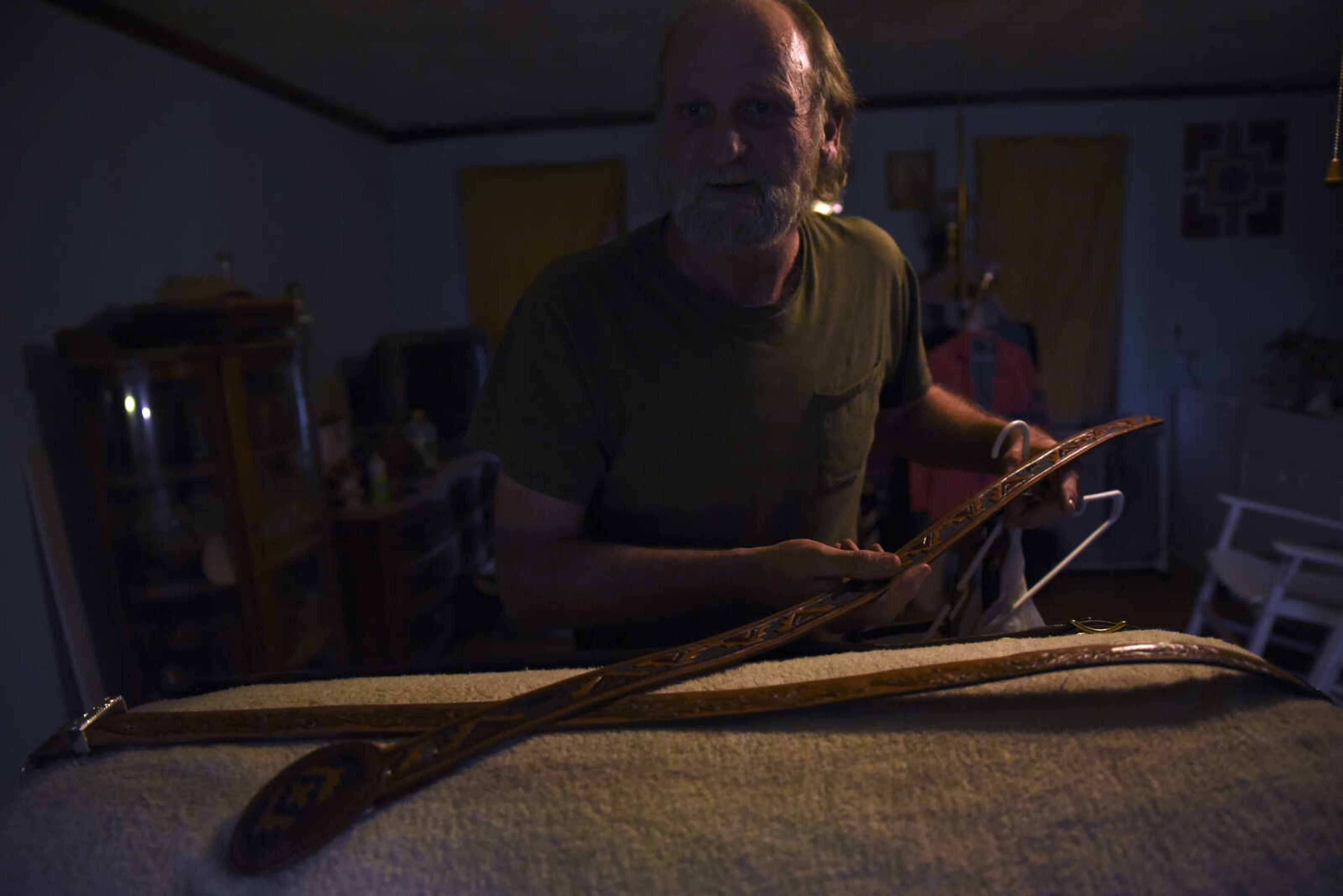 John Hedge lays out leather belts he has hand-made to show in his home on Tuesday, March 27, 2018, in Advance.