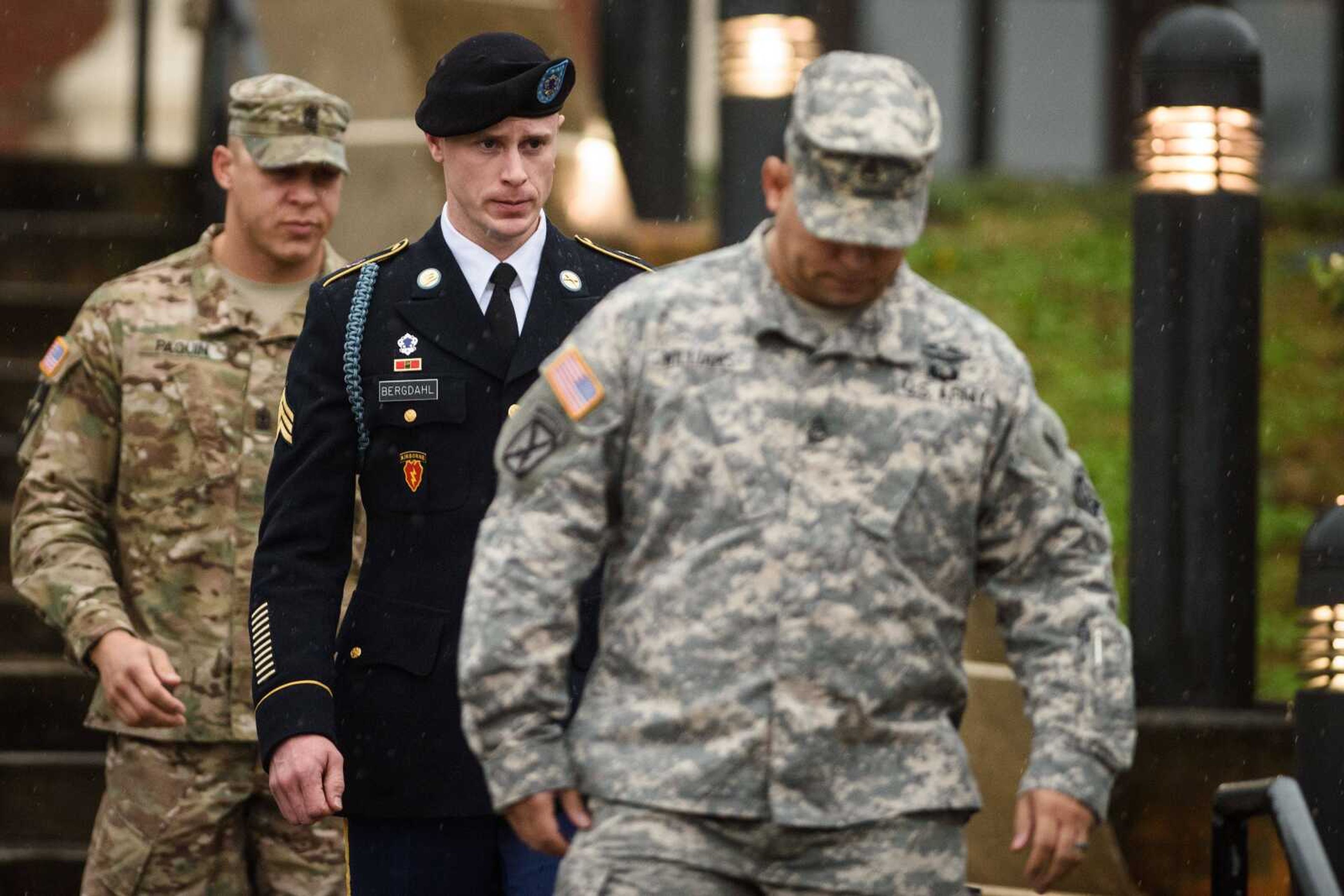 U.S. Army Sgt. Robert Bergdahl, center, leaves the courthouse Tuesday after his arraignment at Fort Bragg, North Carolina. Bergdahl, who disappeared in Afghanistan in 2009 and was held by the Taliban for five years, appeared Tuesday before a military judge on charges of desertion and misbehavior before the enemy. (Andrew Craft ~ The Fayetteville Observer via AP)