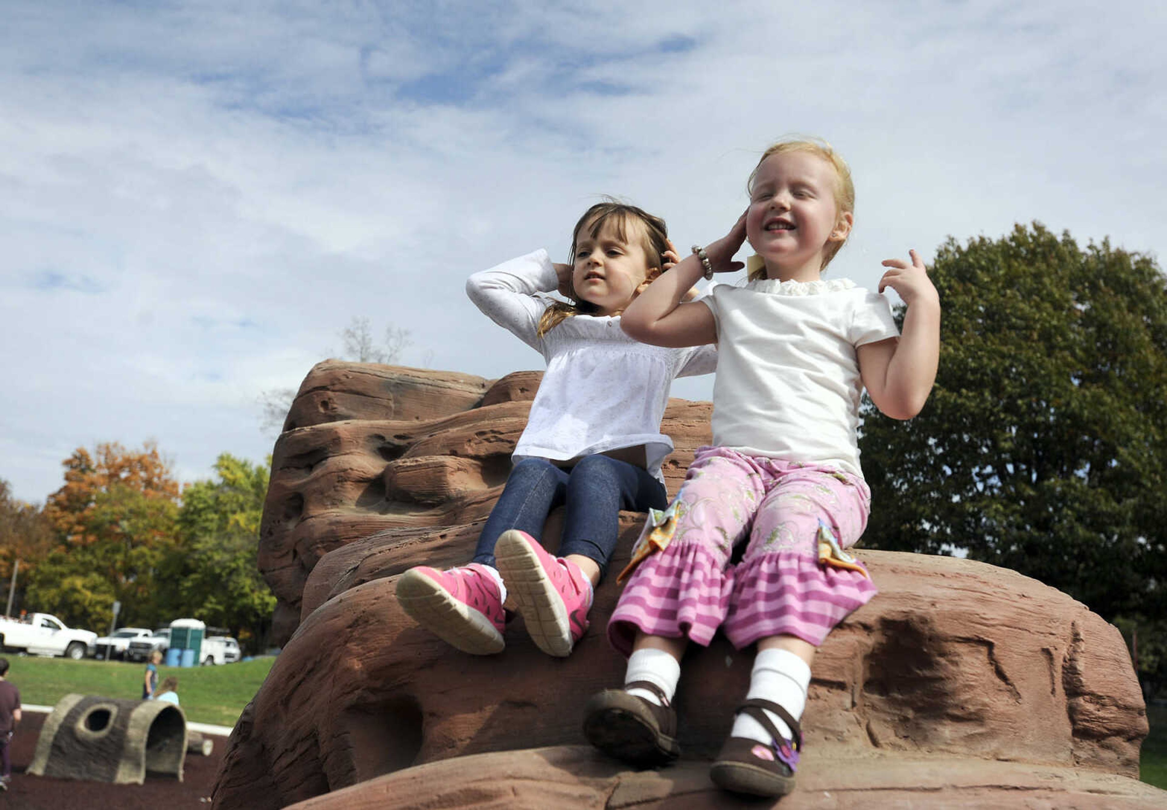 LAURA SIMON ~ lsimon@semissourian.com

Jadie Uzoaru, left, and Joda Grace Bess get their hair out of their faces in preparation for a photo op at the new playground at Capaha Park, Friday, Oct. 23, 2015, in Cape Girardeau.