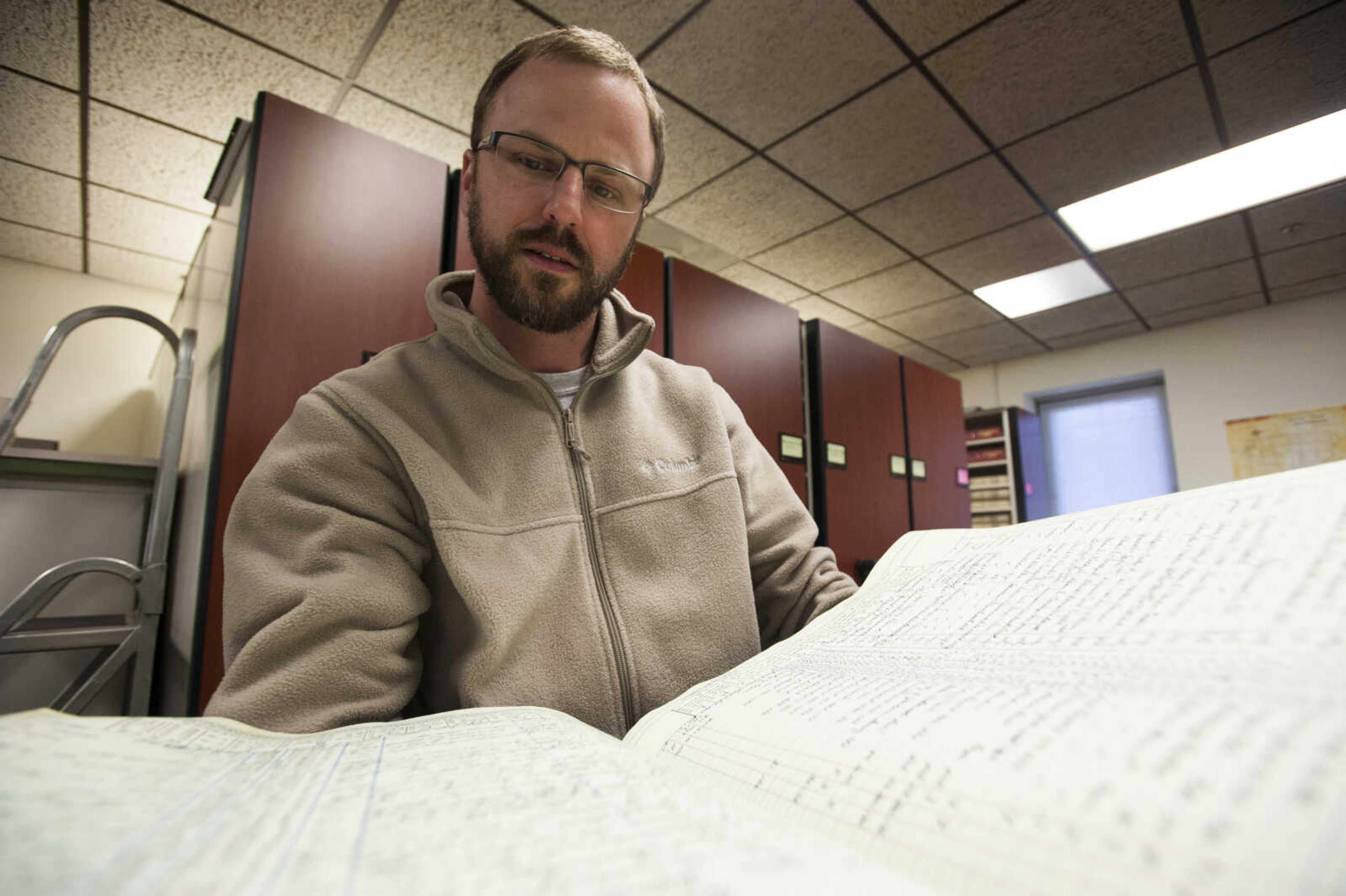 Cape Girardeau County recorder of deeds Andrew Blattner flips through the pages of an index Thursday, March 8, 2018, in the Recorder's Office at the Cape County Administration Building in Jackson.