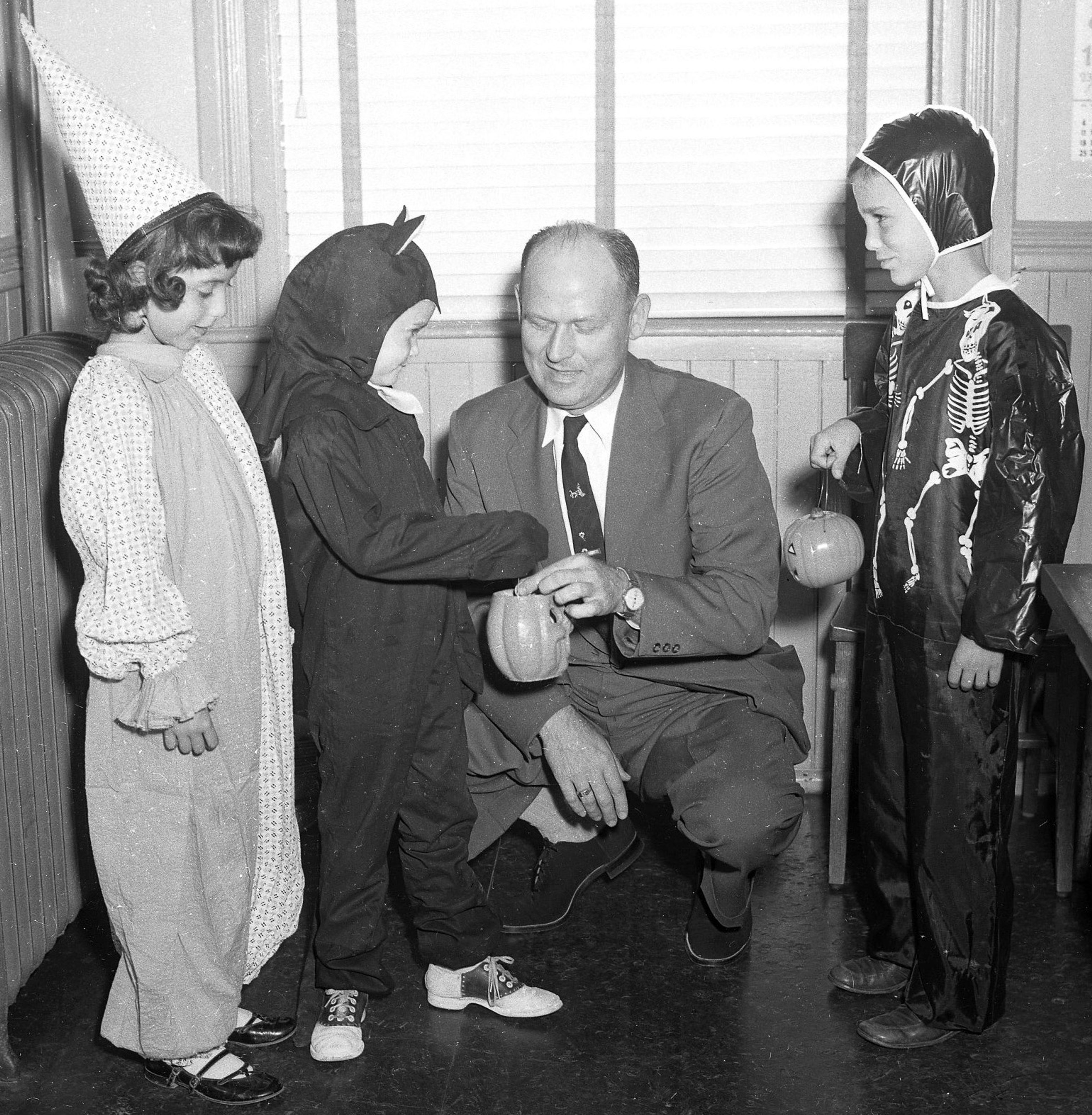 In this Oct. 28, 1955, image, Cape Girardeau Mayor Narvol Randol, center, demonstrates how residents may give their pennies to the United Nations Children's Fund (UNICEF) on Halloween. Dressed in their holiday costumes are, left to right, Donna Kay Reimann, daughter of Mr. and Mrs. Fred Reimann, representing Trinity Lutheran School; Jane McAuley, daughter of Mr. and Mrs. W.F. McAuley, representing St. Vincent's Parochial School, and John Finch, son of Mr. and Mrs. James A. Finch Jr., representing Franklin School.
