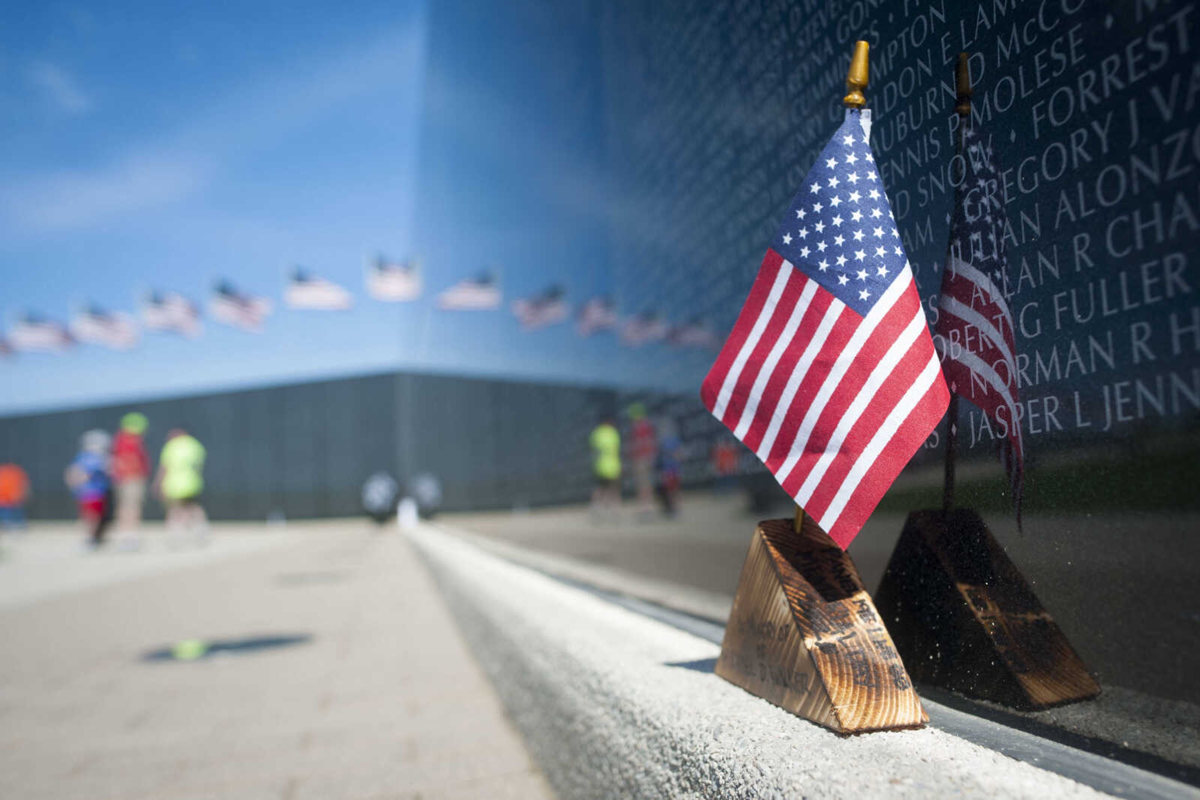 A flag placed in memory of Michael D. Walker rests in front of a panel of Missouri's National Veterans Memorial during Memorial Day on May 25, 2020, in Perryville, Missouri. A hand-written message that read "Daddy, My Hero," was located on one side of the flag's wooden base.