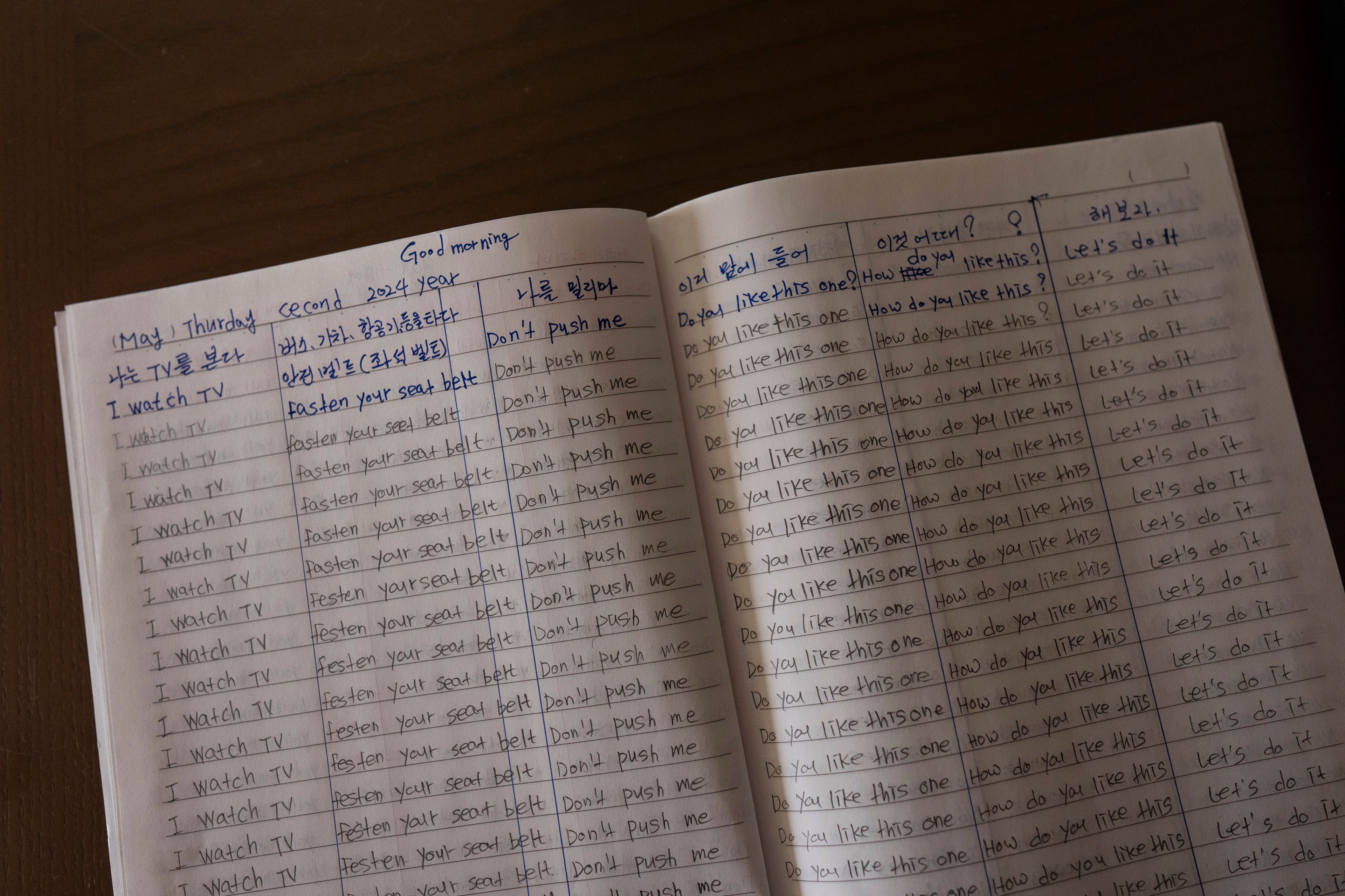 Han Tae-soon's notebook sits on a table at her home in Anyang, South Korea, Saturday, June 1, 2024. Han, who is in her 70s, has notebooks feverishly annotated with English translations, written during countless hours trying to learn her daughter's language. (AP Photo/Jae C. Hong)