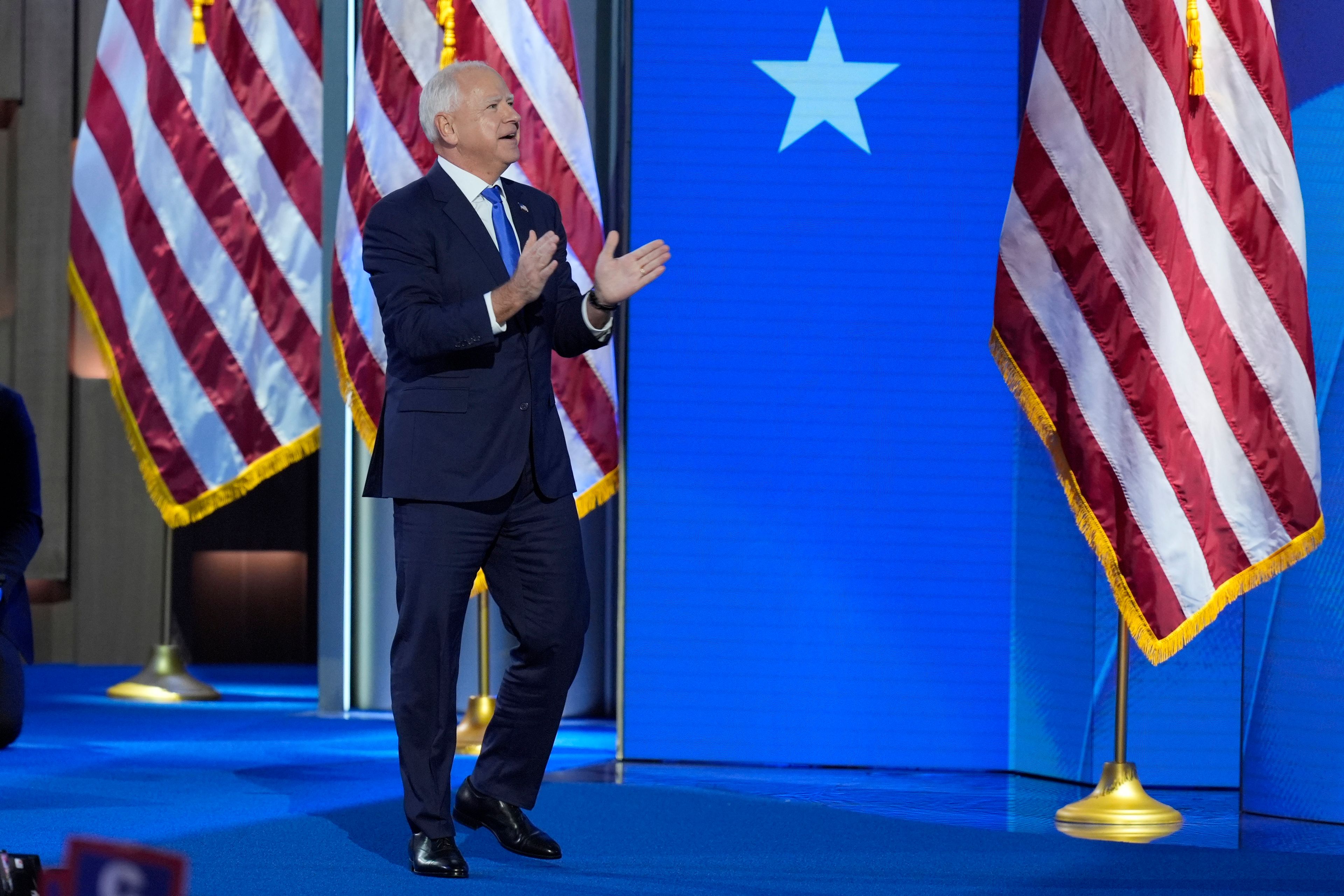 Democratic vice presidential nominee Minnesota Gov. Tim Walz walks on stage to speak during the Democratic National Convention Wednesday, Aug. 21, 2024, in Chicago. (AP Photo/J. Scott Applewhite)