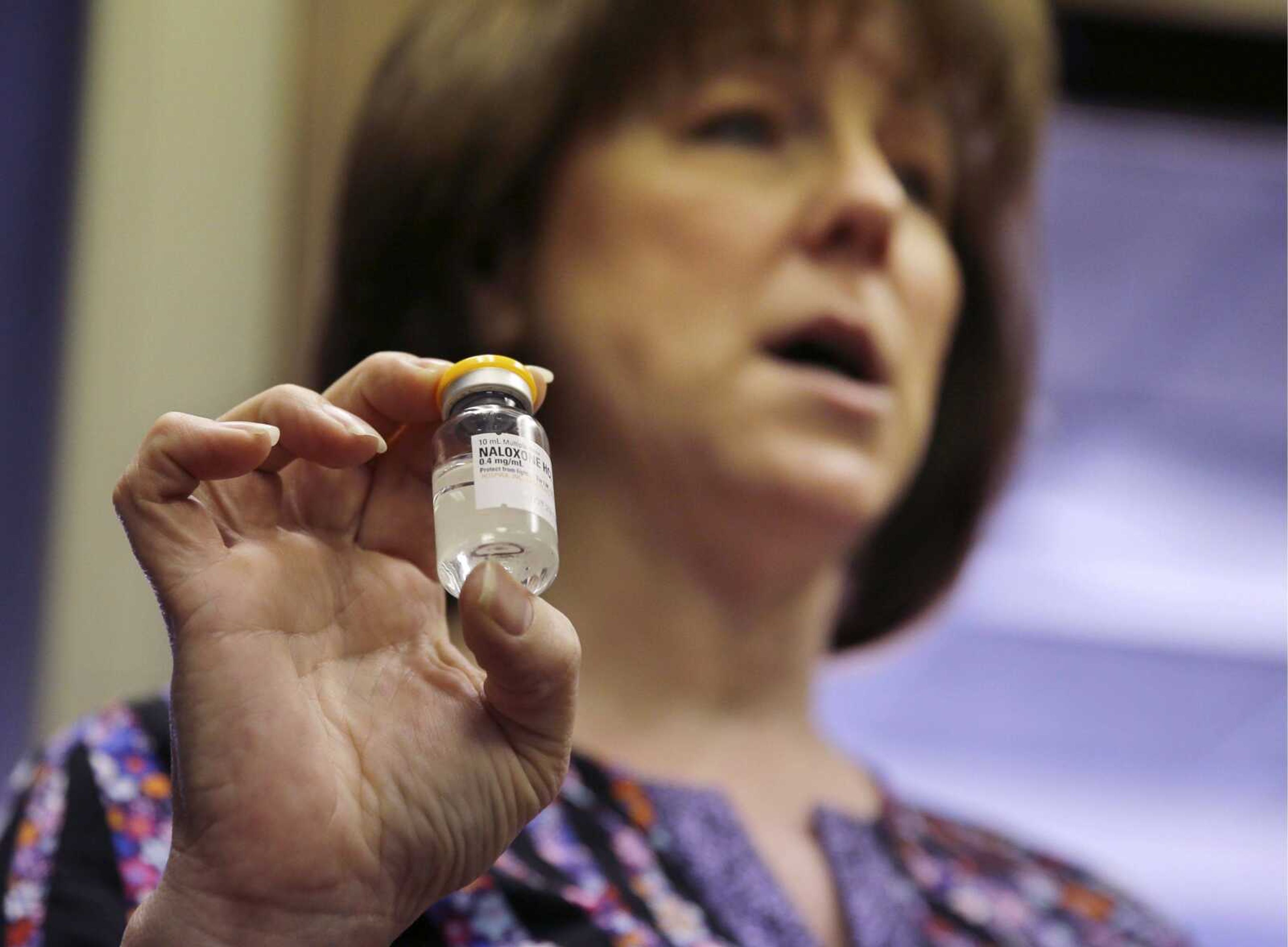 Registered nurse Babette Richter, with the South Jersey AIDS Alliance, holds up a container of the heroin overdose antidote naloxone, also known by its brand name Narcan, on Feb. 22 in Camden, N.J. An overdose of opiates essentially makes the body &#8220;forget&#8221; to breathe. Naloxone works by blocking the brain receptors that opiates latch onto and helping the body &#8220;remember&#8221; to take in air. (Mel Evans ~ Associated Press)