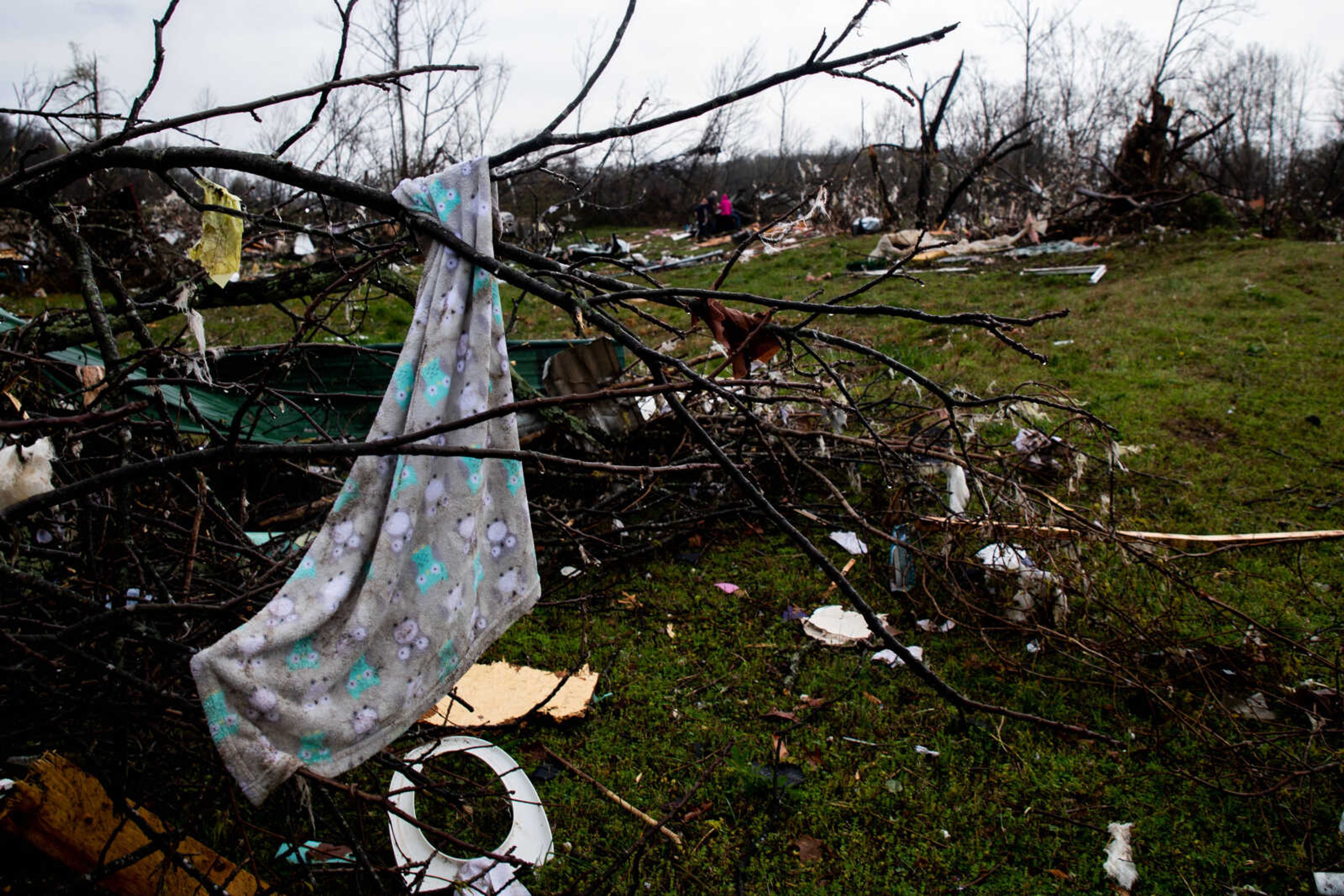 A baby blanket hangs in the branches of a tree near the mobile home where five died in a tornado on Wednesday, April 5 in Glen Allen.