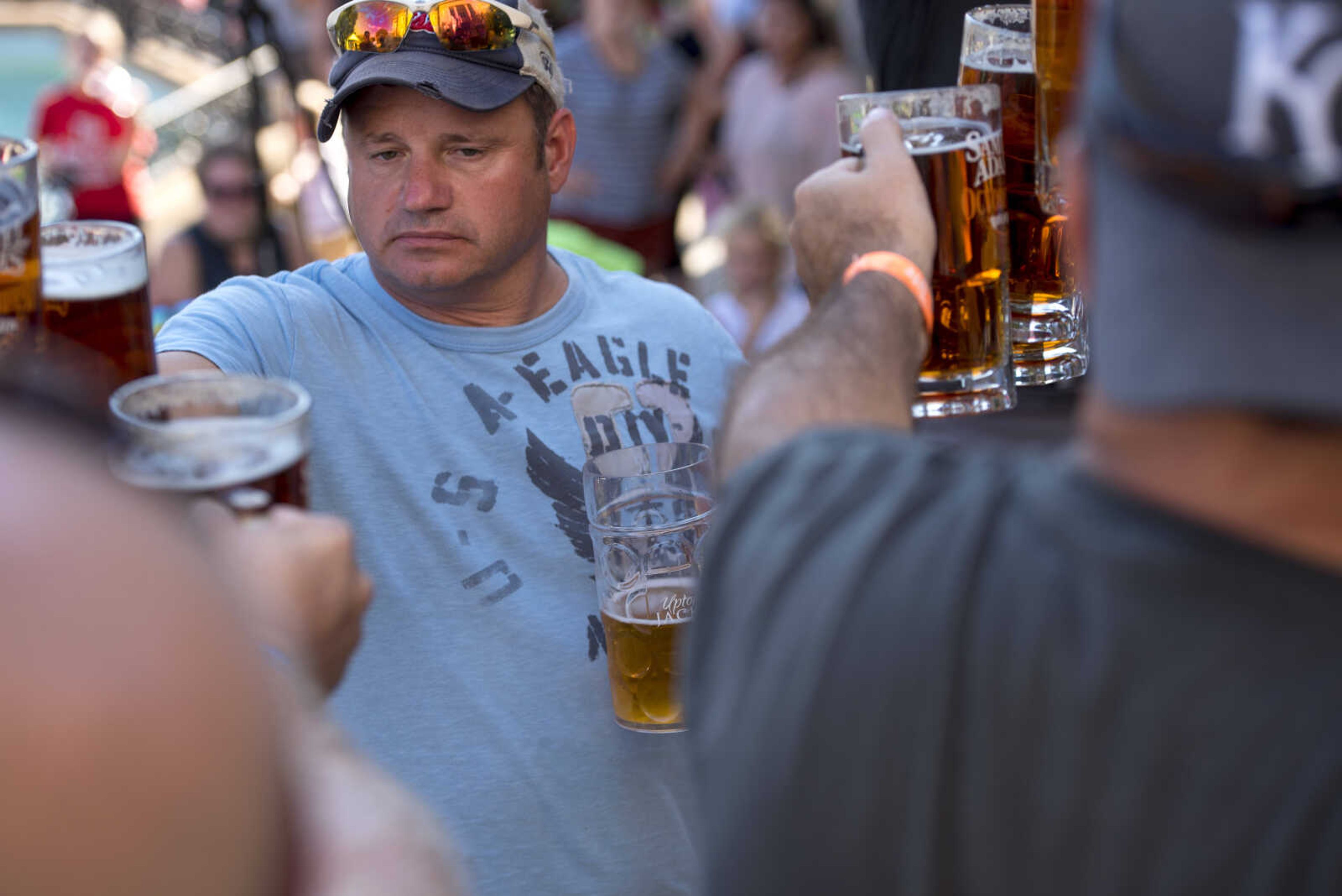 Contestants toast during a stein-holding competition during Uptown Jackson Oktoberfest Saturday, Oct. 6, 2018.