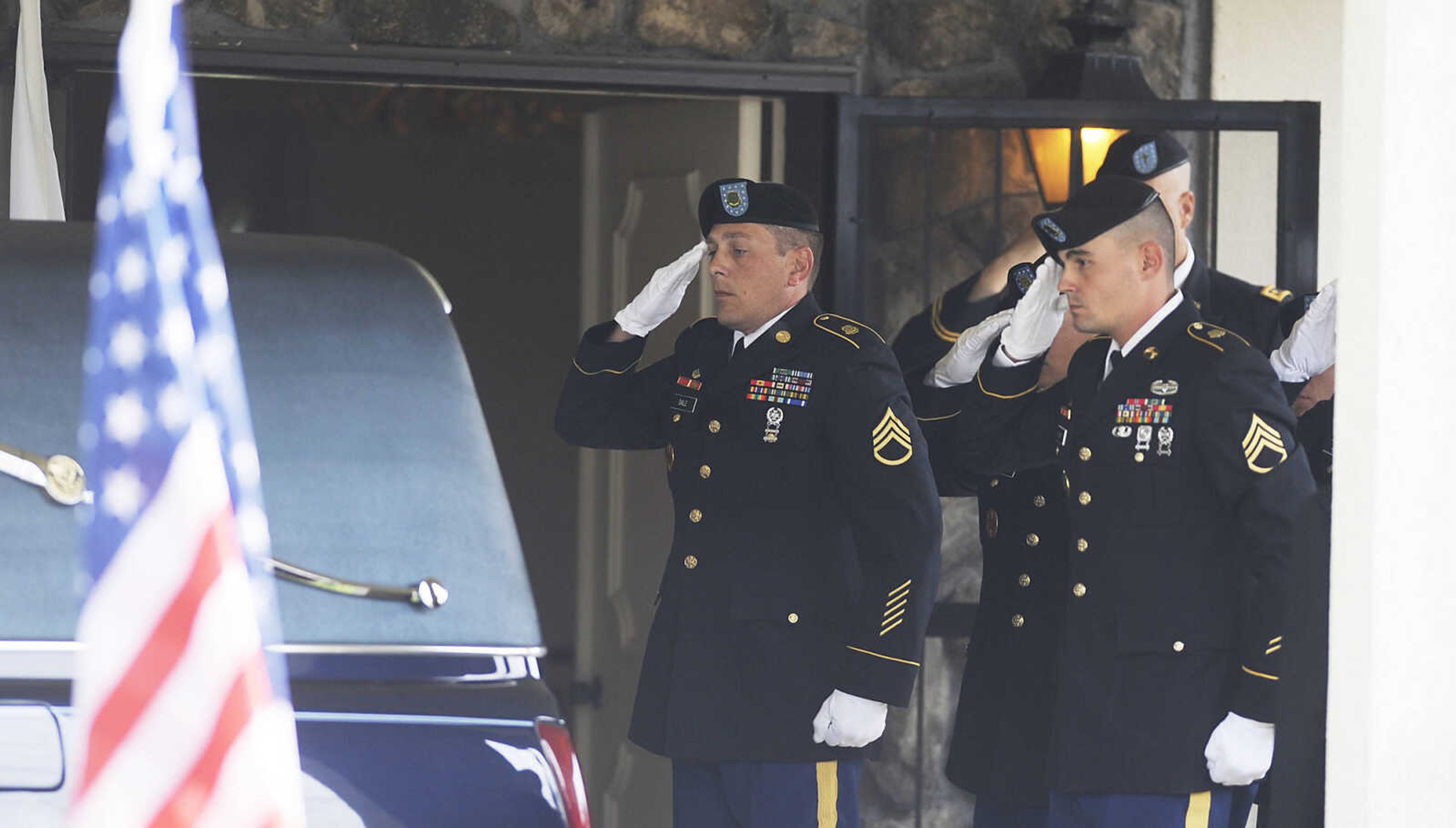 An honor guard salutes after U.S. Army Air Forces 1st Lt. Warren G. Moxley is loaded into a hearse Tuesday, July 3, at McMikle Funeral Home in Charleston, Mo. A pilot with the 67th Tactical Recon Group's 107th Observation Squadron Moxley was killed on March 15, 1945, when his F6, a photo-reconnaissance model of the P-51 Mustang, was shot down over Germany by anti-aircraft fire. His remains were identified using DNA earlier this year.