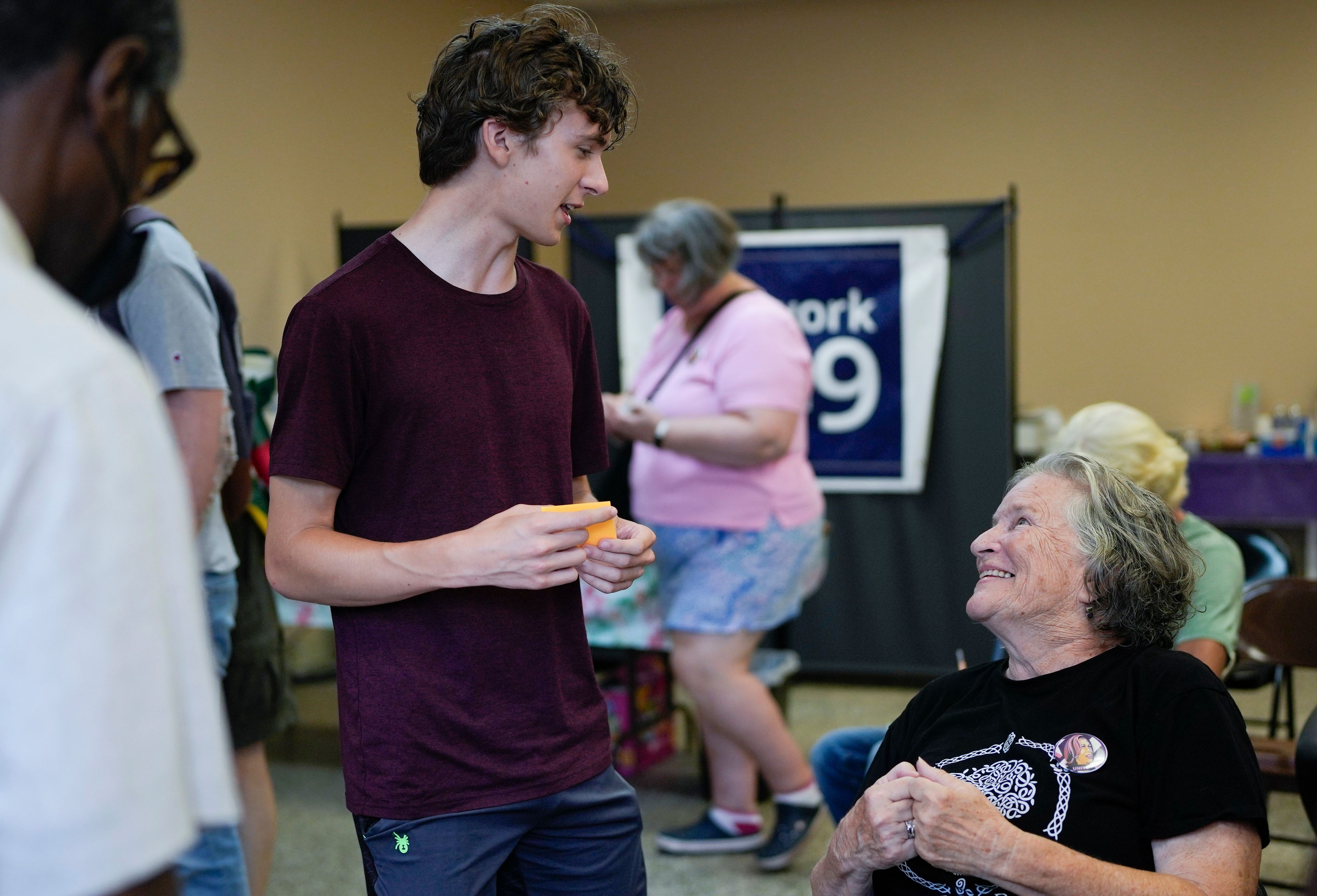 Katy Hogan, right, an organizer with Operation Swing State, talks to 17-year-old volunteer Elijah Jackson during a meeting of those who will be canvassing for Vice President Kamala Harris and other Democrats in Michigan and Wisconsin, Sunday, July 28, 2024, at the 49th Ward offices in Chicago. (AP Photo/Erin Hooley)