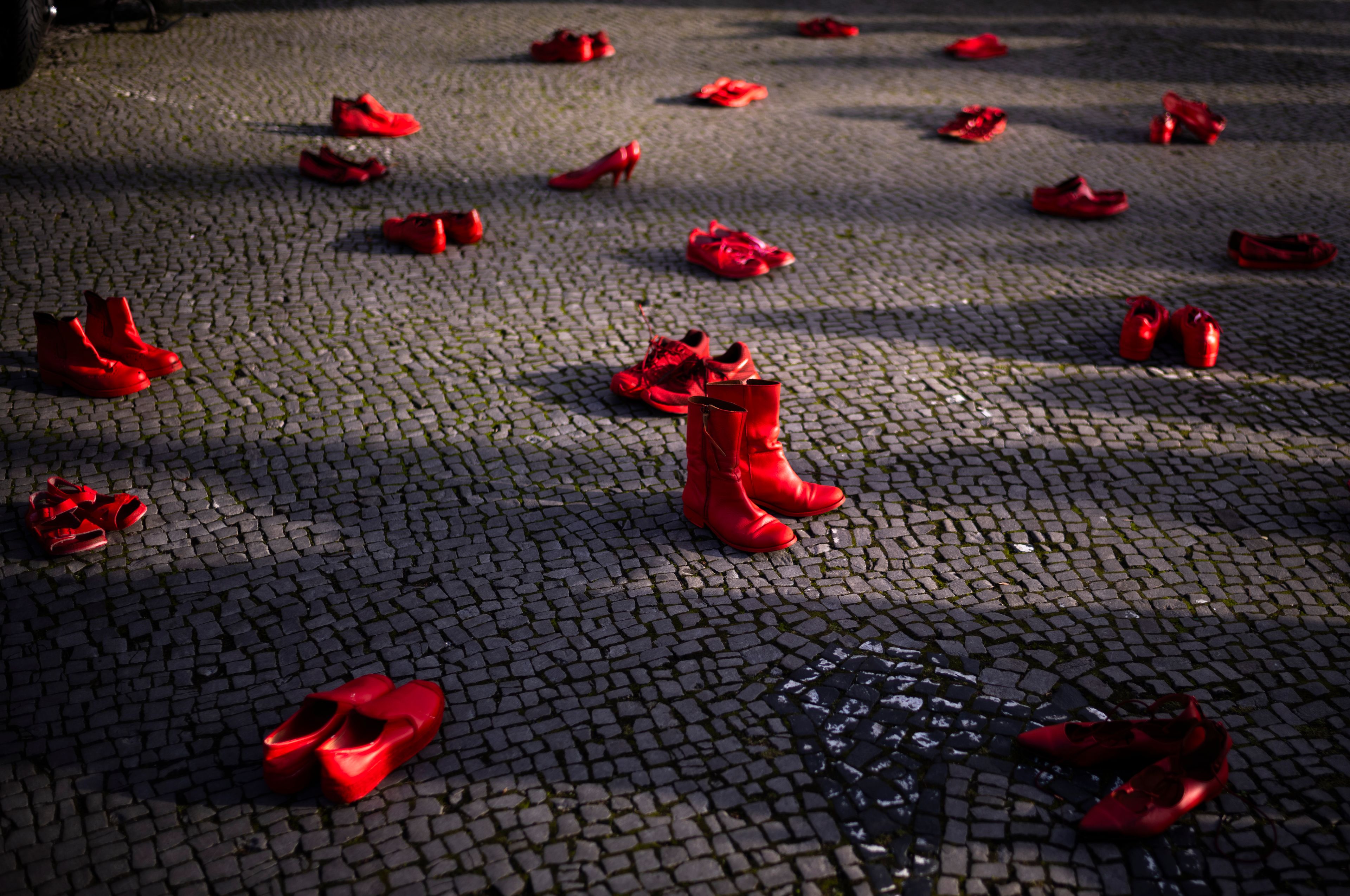 Red shoes placed on the ground as a symbol against the violence on women, during a rally marking the International Day for the Elimination of Violence Against Women, in Berlin, Germany, Monday, Nov. 25, 2024. (AP Photo/Markus Schreiber)