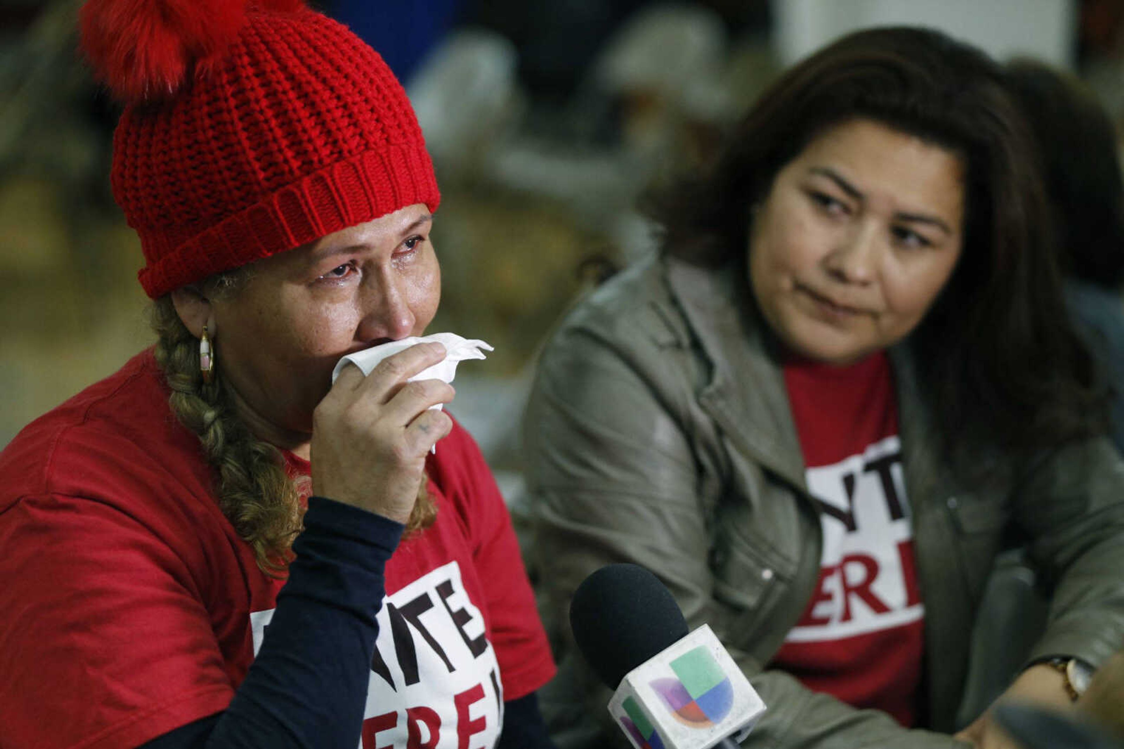 El Salvador immigrants Diana Paredes, left, and Isabel Barrera react at a news conference following an announcement on Temporary Protected Status for nationals of El Salvador on Monday in Los Angeles.