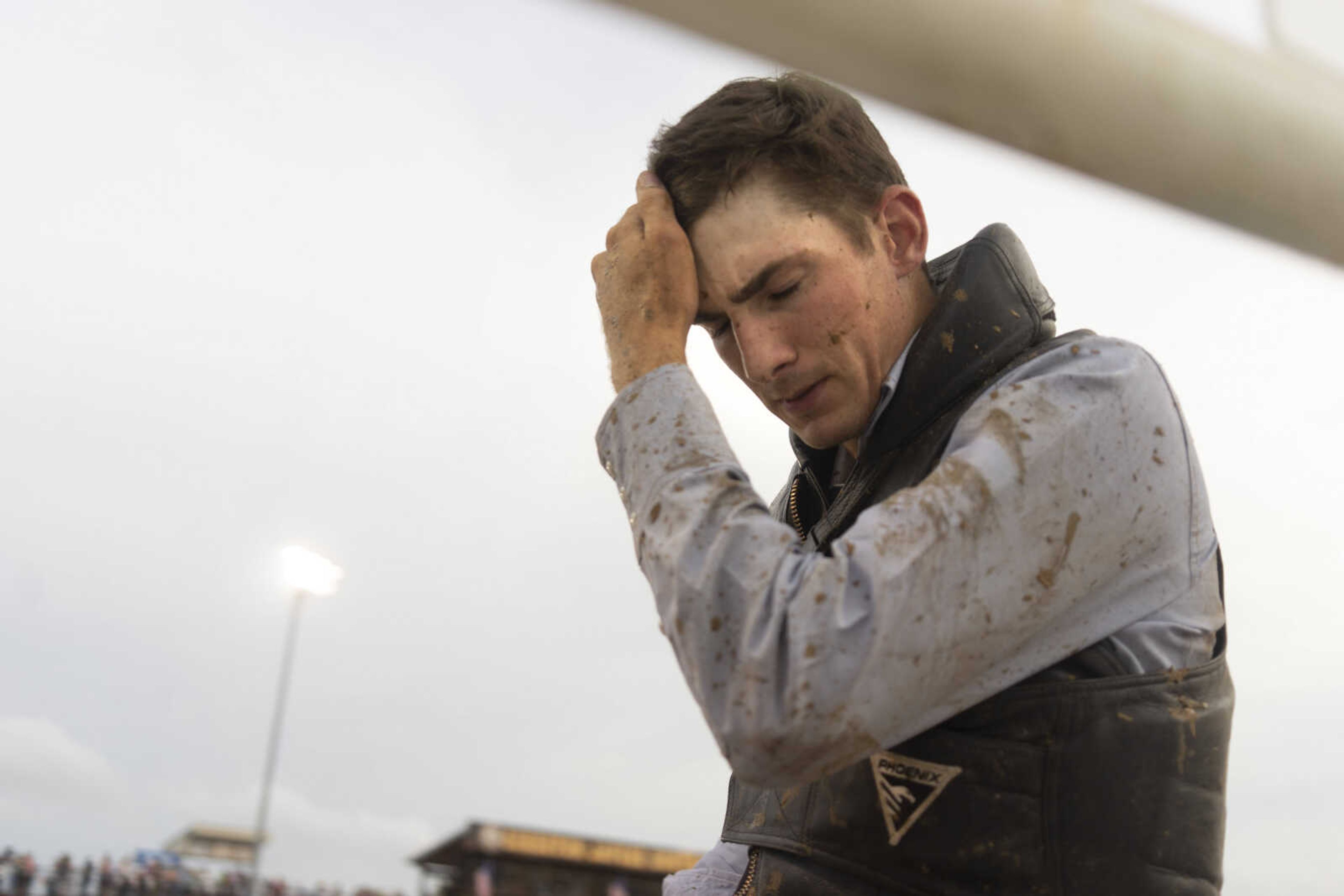 &nbsp;A performer wipes the mud from his forehead as he leaves the arena after completing his ride at the Sikeston Jaycee Bootheel Rodeo Friday, Aug. 13, 2021, in Sikeston, Missouri.