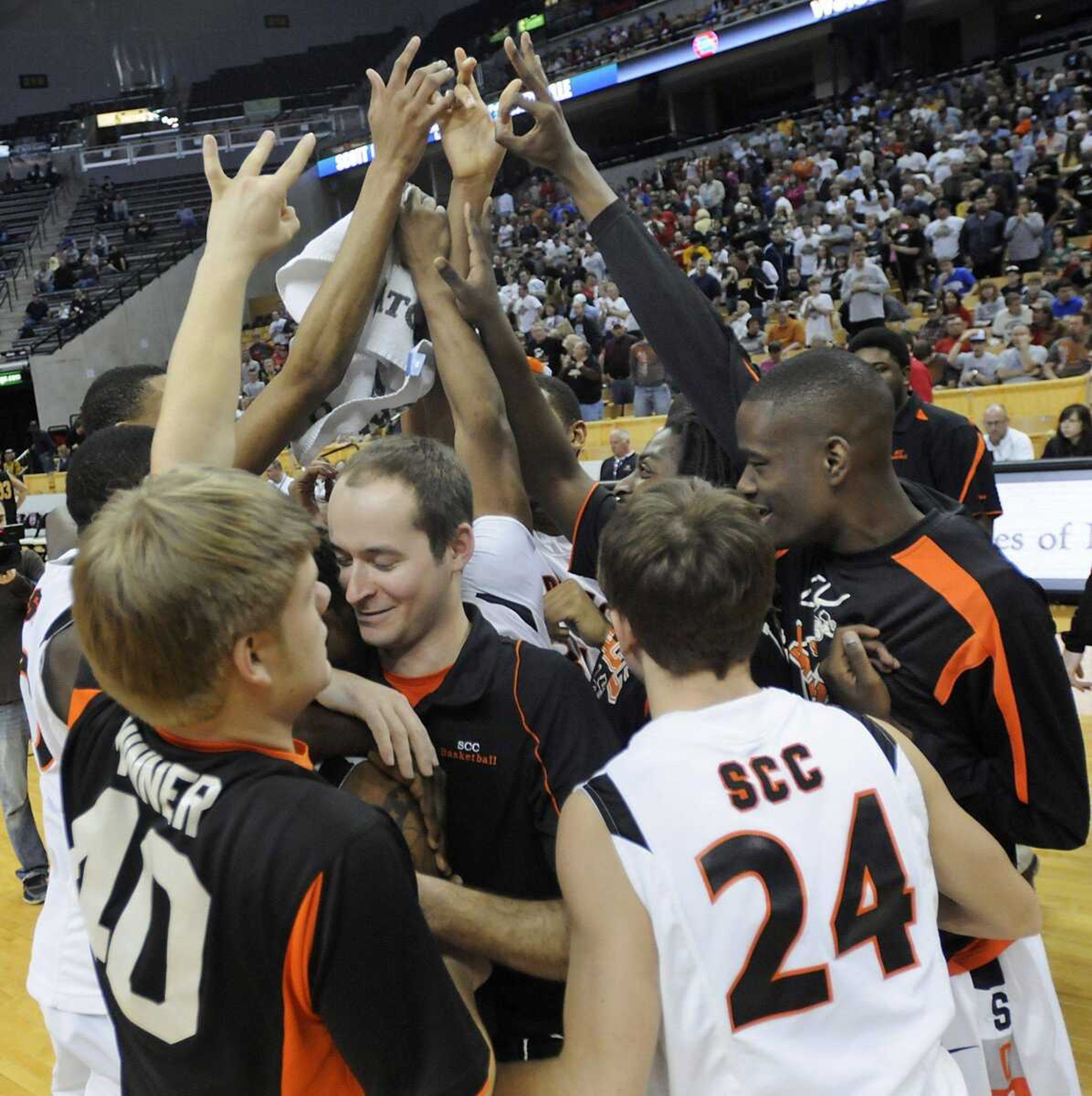 Scott County Central coach Kenyon Wright, center, celebrates with his players after the Braves defeated Dadeville in the Class 1 championship game in Columbia, Mo.