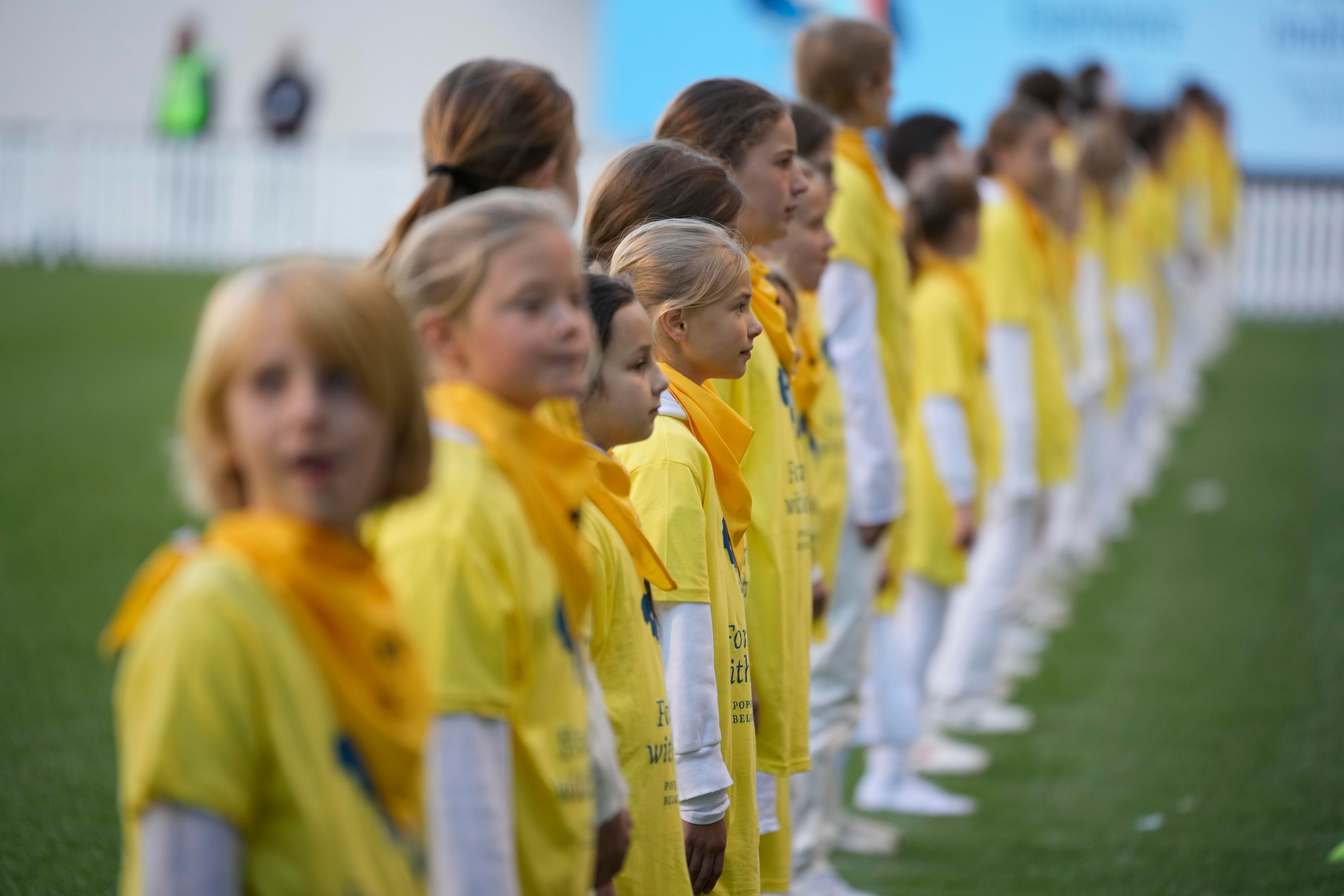 Faithful wait for the start of a mass presided by Pope Francis at King Baudouin Stadium, in Brussels Sunday, Sept. 29, 2024. (AP Photo/Andrew Medichini)