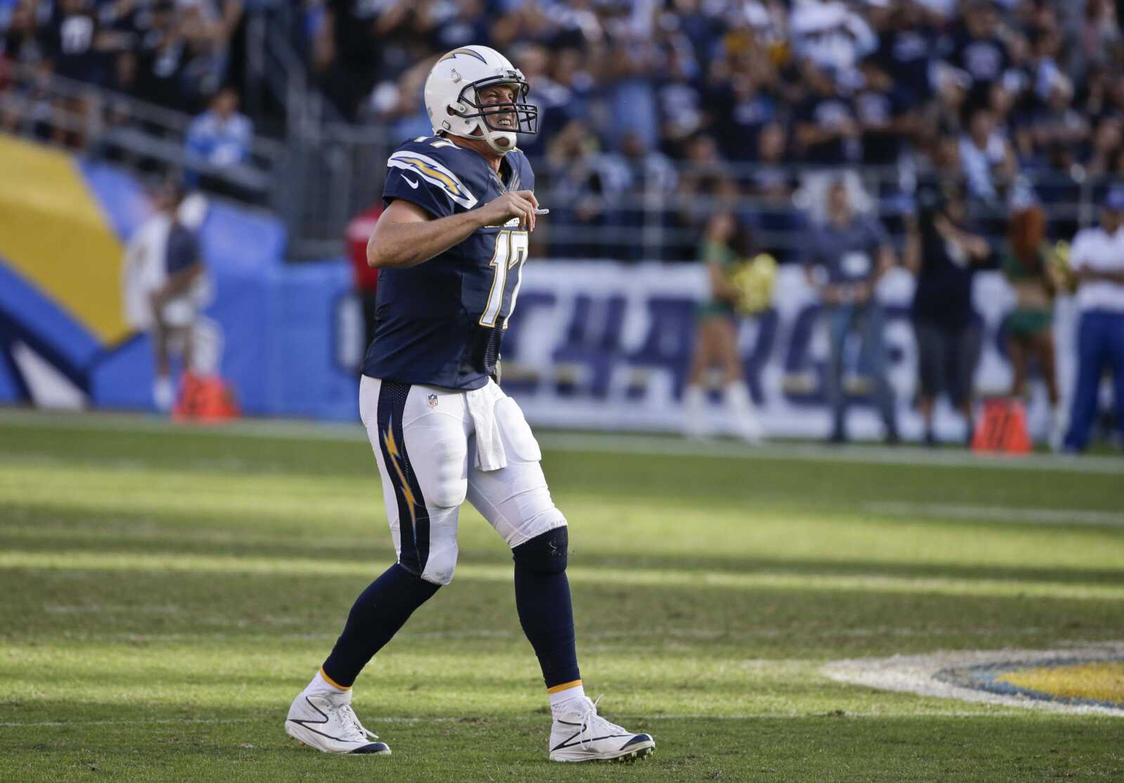 San Diego Chargers quarterback Philip Rivers limps before going to his knees after being hurt during the second half of last week's game against the Oakland Raiders in San Diego. (Gregory Bull ~ Associated Press)