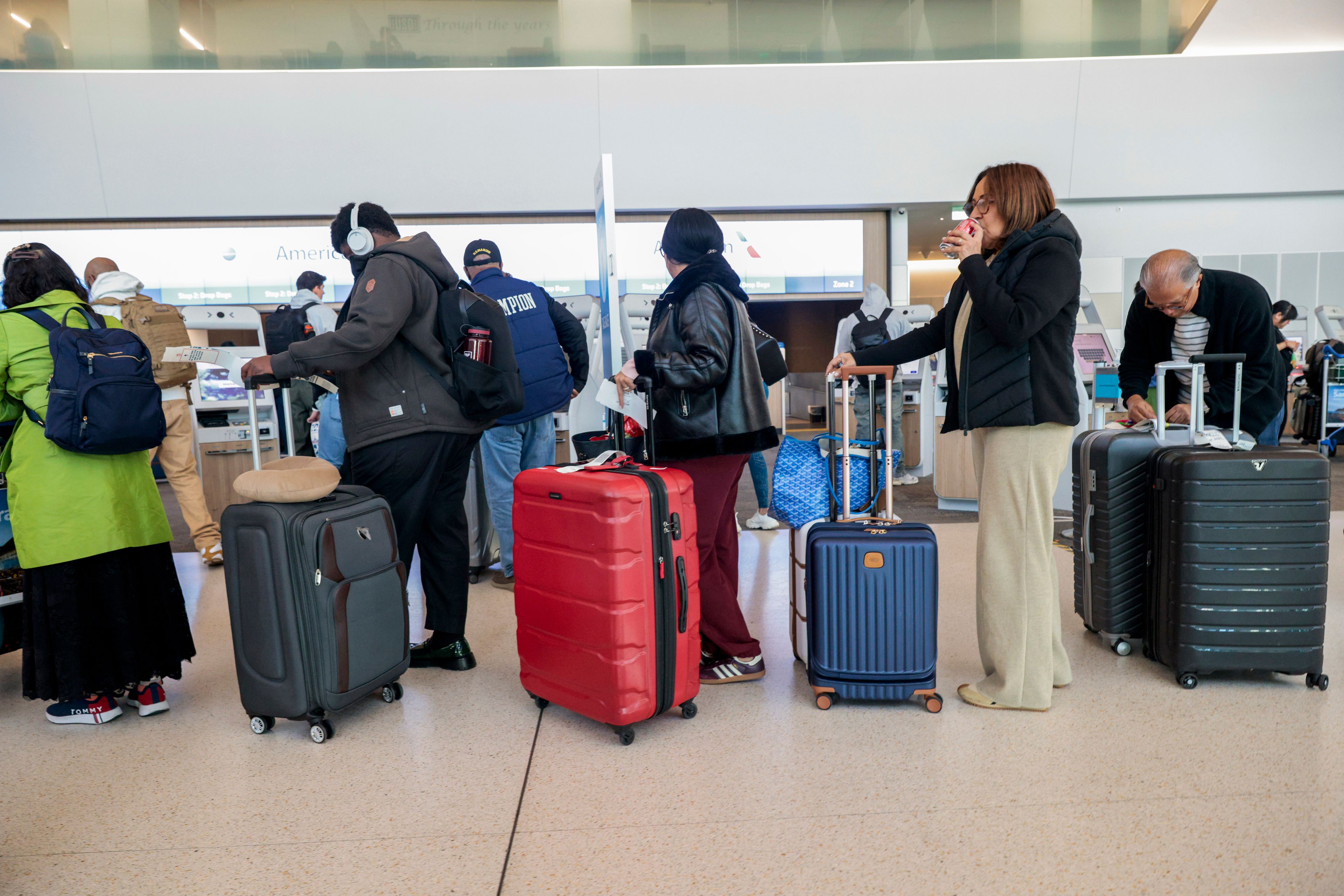 Travelers line up to check in their bags into San Francisco International Airport on Wednesday, Nov. 27, 2024. (Santiago Mejia/San Francisco Chronicle via AP)