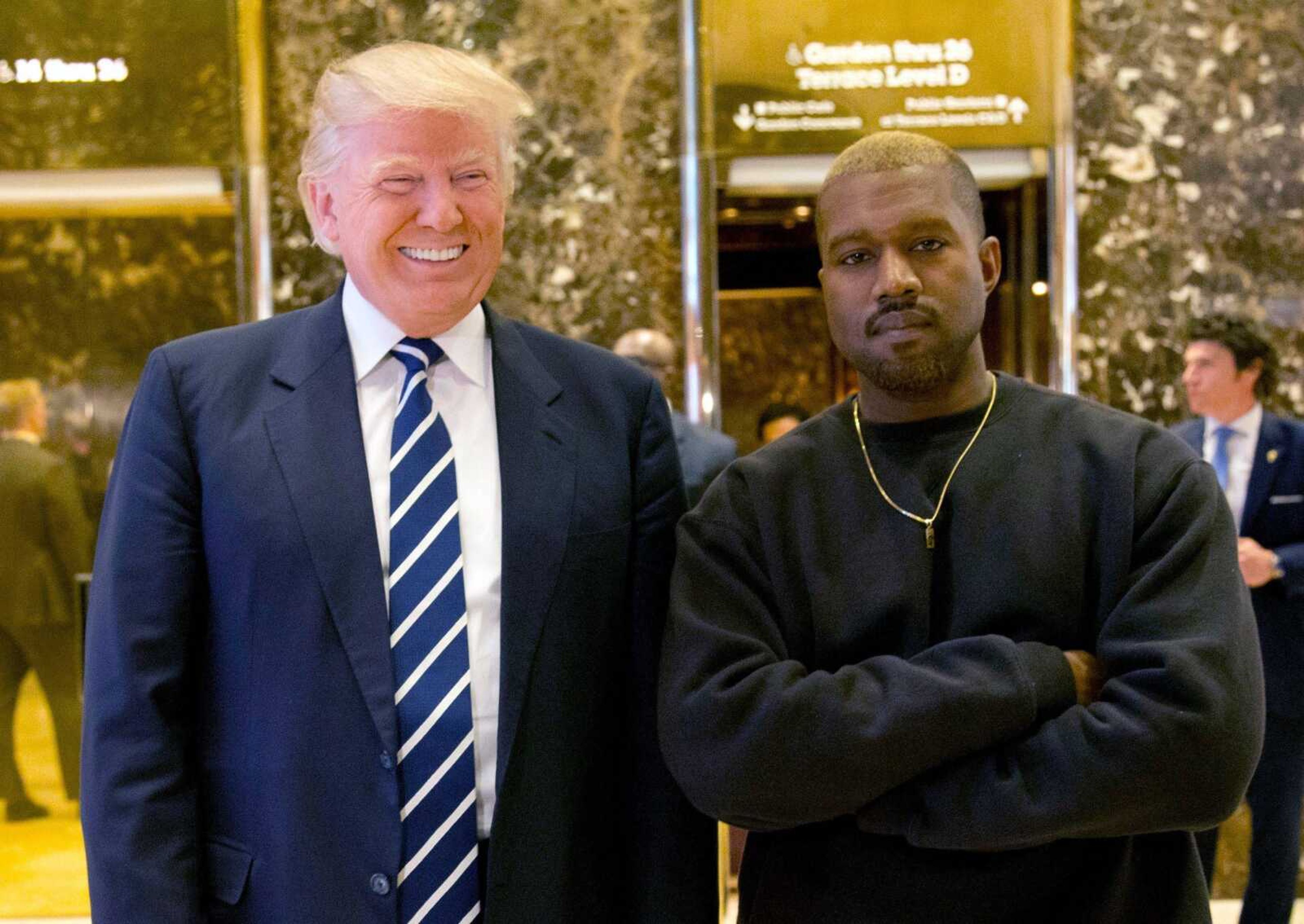 Then-President-elect Donald Trump and Kanye West pose for a picture Dec. 13, 2016, in the lobby of Trump Tower in New York. Trump is tweeting his thanks to rap superstar Kanye West for his recent online support. Trump wrote, "Thank you Kanye, very cool!" in response to the tweets from West, who called the president "my brother." West tweeted several times Wednesday expressing his admiration for Trump, saying they both share "dragon energy." The rap star also posted a photo of himself wearing Trump's campaign "Make America Great Again" hat.