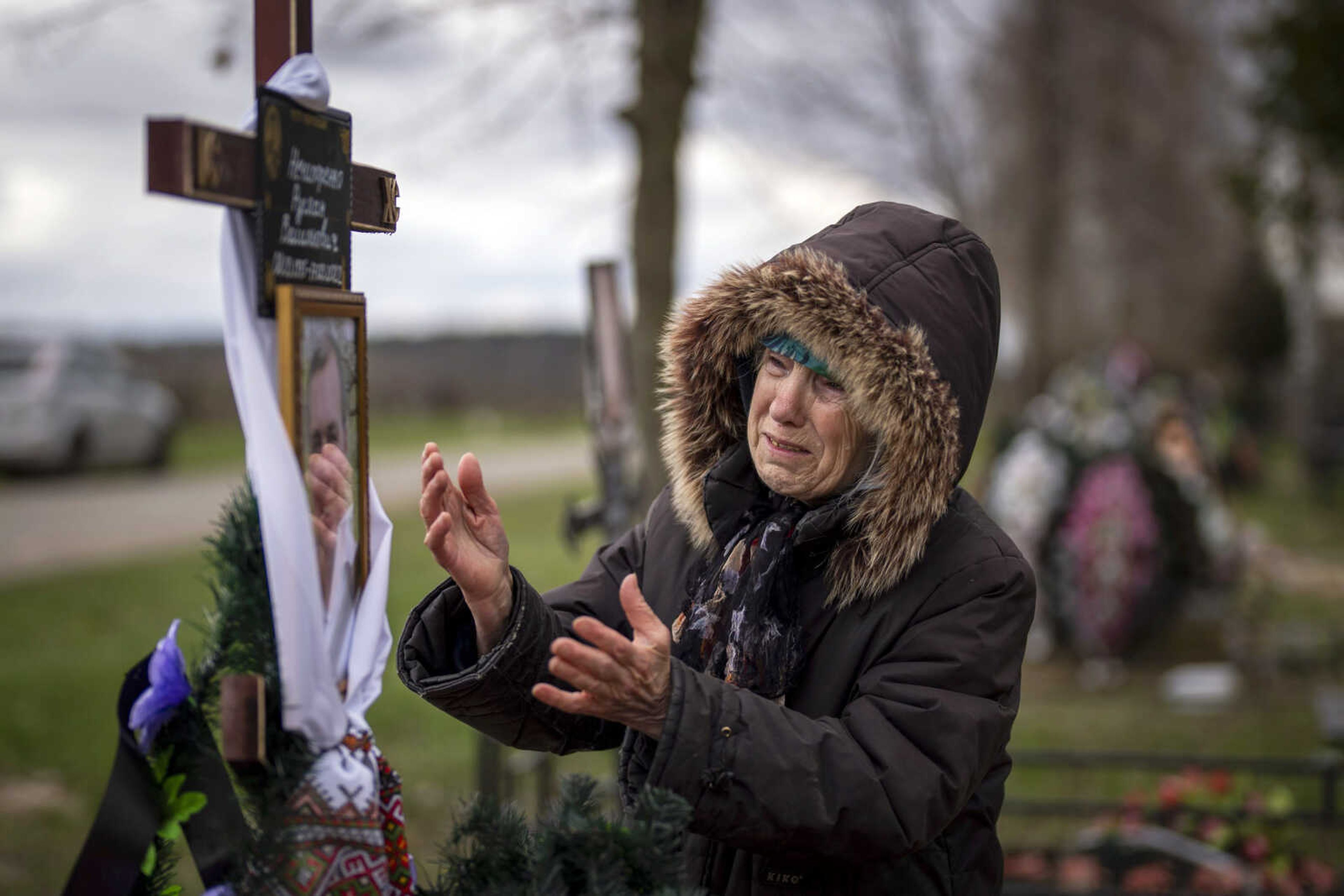 Valentyna Nechyporenko, 77, mourns at the grave of her 47-year-old son Ruslan, during his funeral Monday at the cemetery in Bucha, on the outskirts of Kyiv, Ukraine. Ruslan was killed by Russian army March 17 while delivering humanitarian aid to his neighbours in the streets of Bucha.