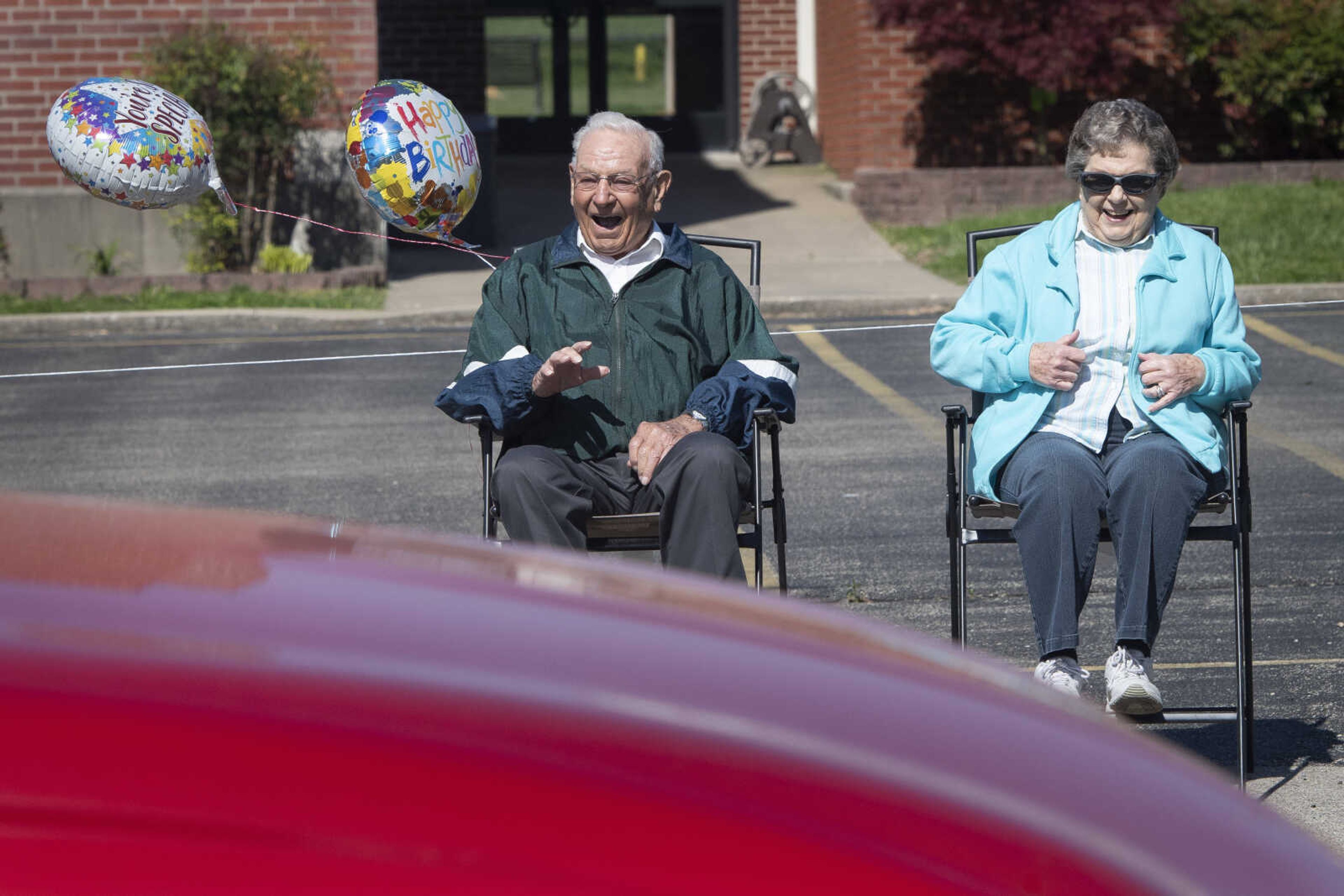 On his 90th birthday, Paul L. Essner of Benton, Missouri, and his wife Bert Essner react to a parade celebrating Paul's birthday Saturday, April 18, 2020, outside St. Denis Catholic School in Benton, Missouri. Betty Essner of Benton, Paul's daughter-in-law, said they had a 90th birthday party and open house planned for Paul at the St. Denis parish center, but it was cancelled due to the COVID-19 pandemic. However, in lieu of the party, it was decided to have a parade. "It's a little sad," Betty said of the change in plans. "We were really looking forward to having everybody together because we're a big family and we're spread out." Numerous vehicles and their occupants paraded past where Paul and Bert were seated for about 15 minutes in all.