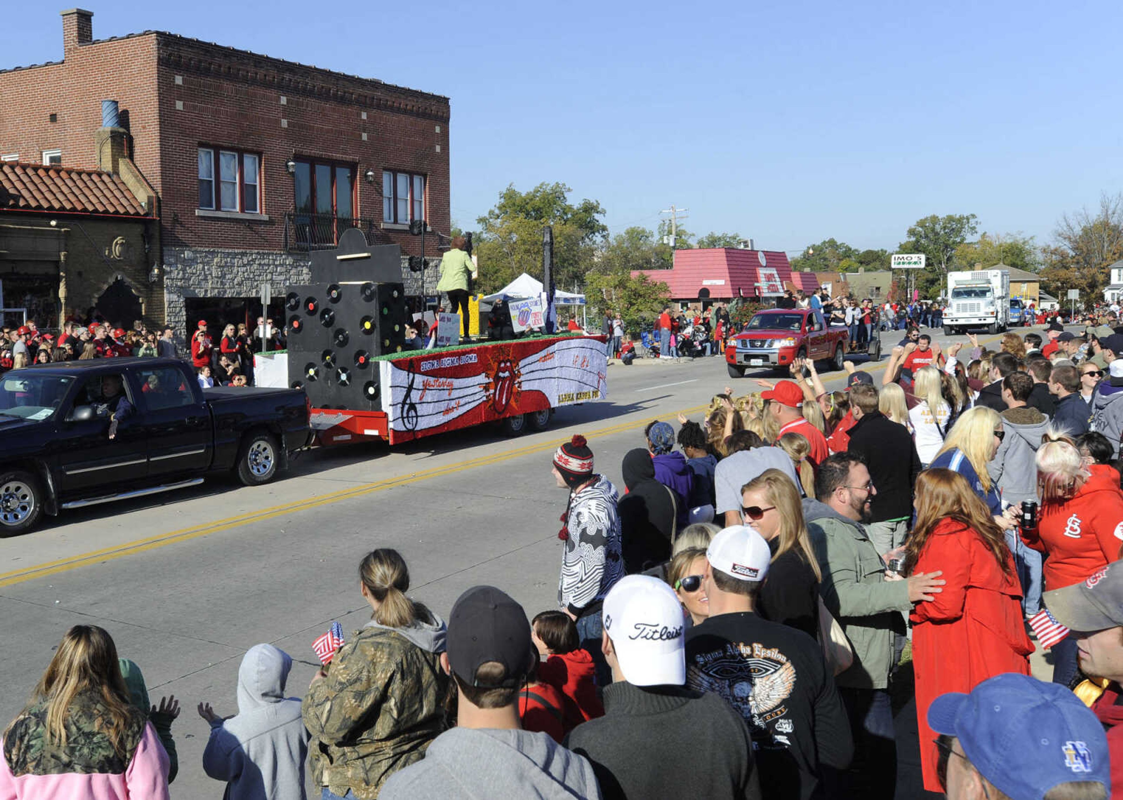 People line the homecoming parade route as the Rolling Stones float goes by.