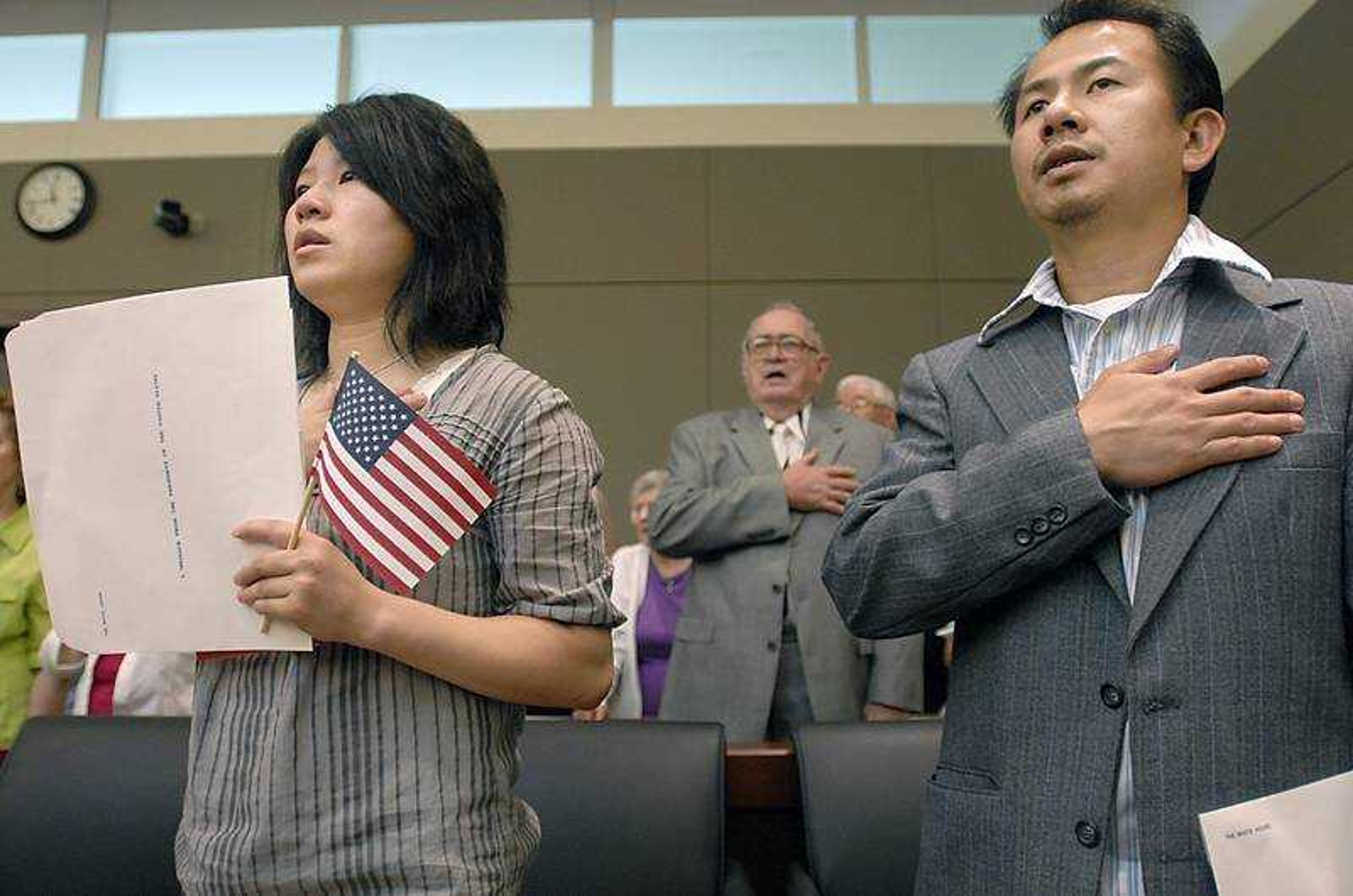 KIT DOYLE ~ kdoyle@semissourian.com
Lanqin Ni, left, of China, and Joselito Rizaldo Babaran Iringan, of the Philippines, sang the national anthem for the first time as U.S. citizens Friday at the Rush H. Limbaugh Sr. U.S. Courthouse in Cape Girardeau.