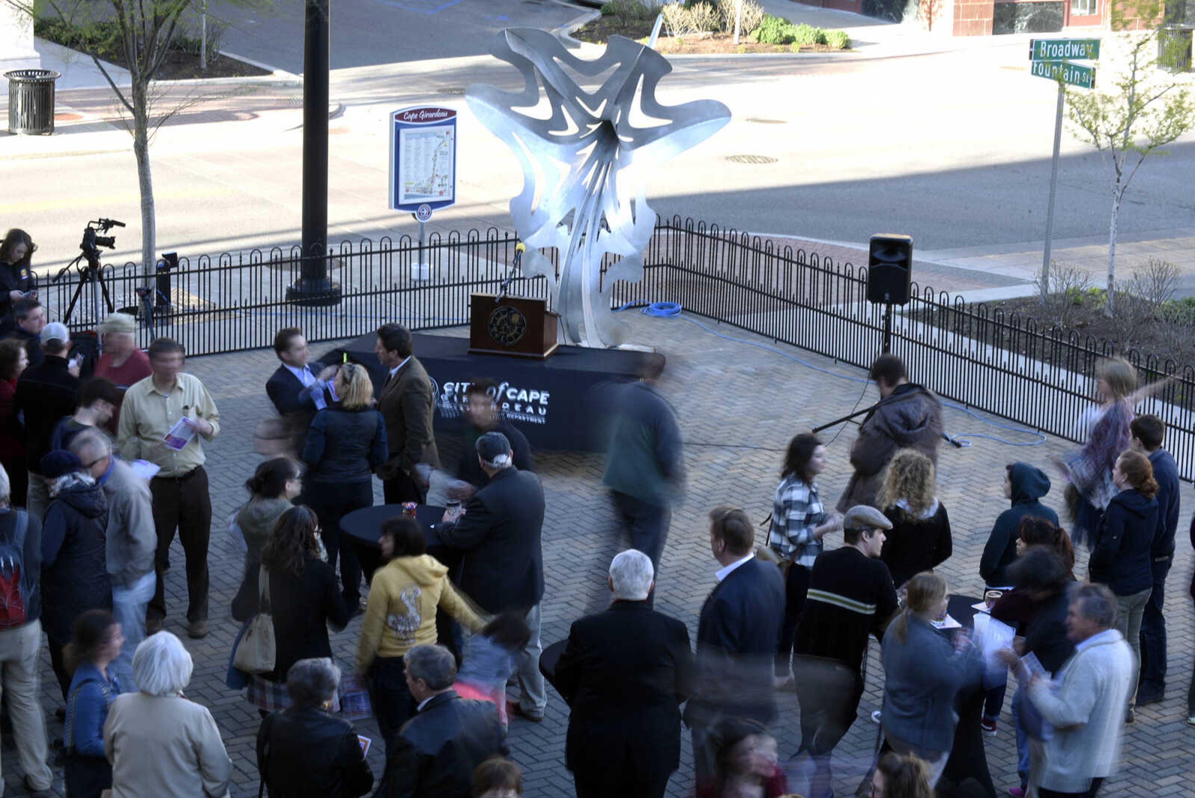 People gather for the opening reception of the 2017 Cape Girardeau Outdoor Sculpture Exhibit on Thursday, April 6, 2017.