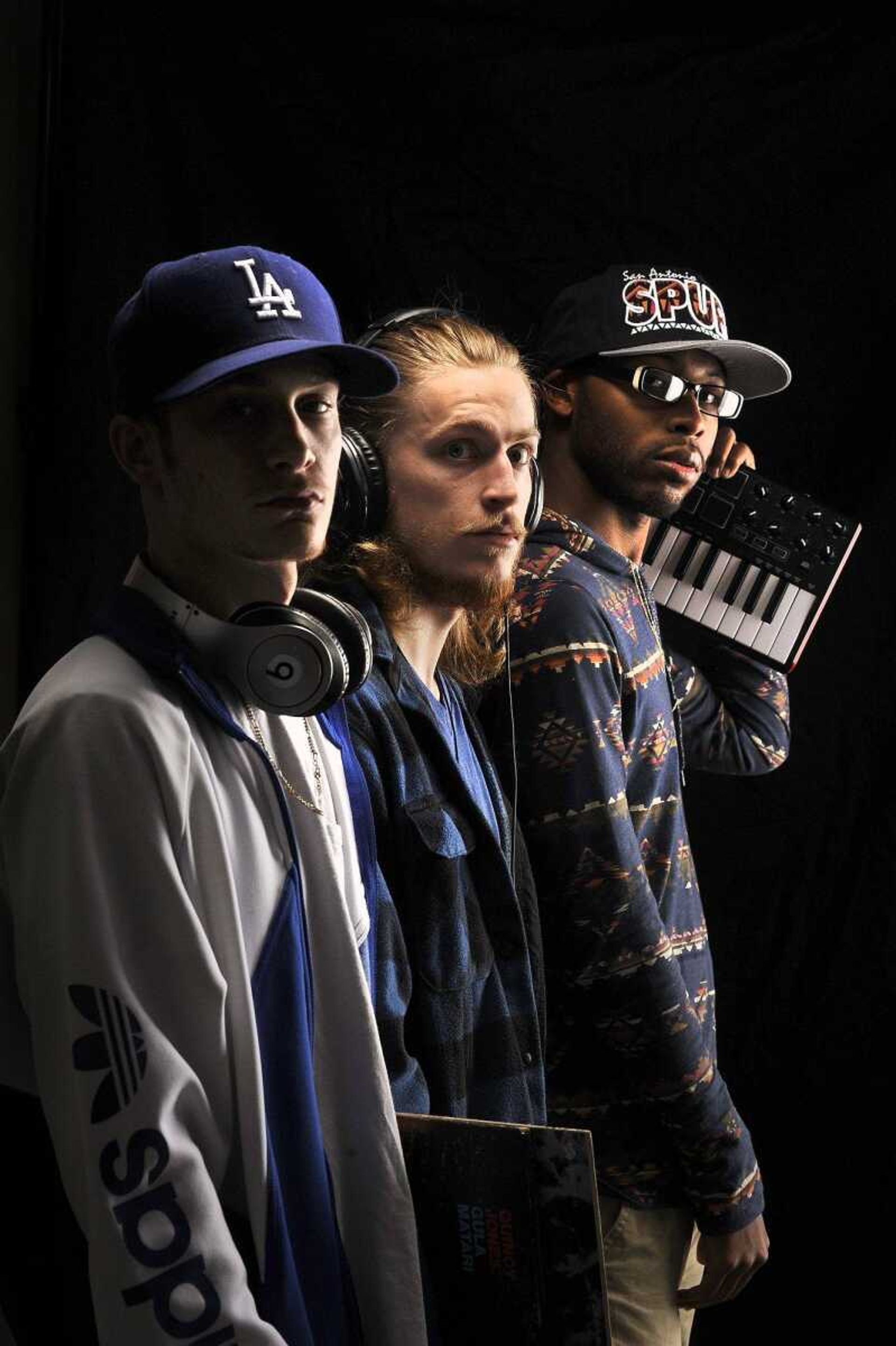 Nik " Niko Scarpy" Scarpaci, left, Angelo "Gelo" Wilson, center, and Amir "Amirical" Waters of hip-hop group Imaginary Friends pose for a photo Wednesday.