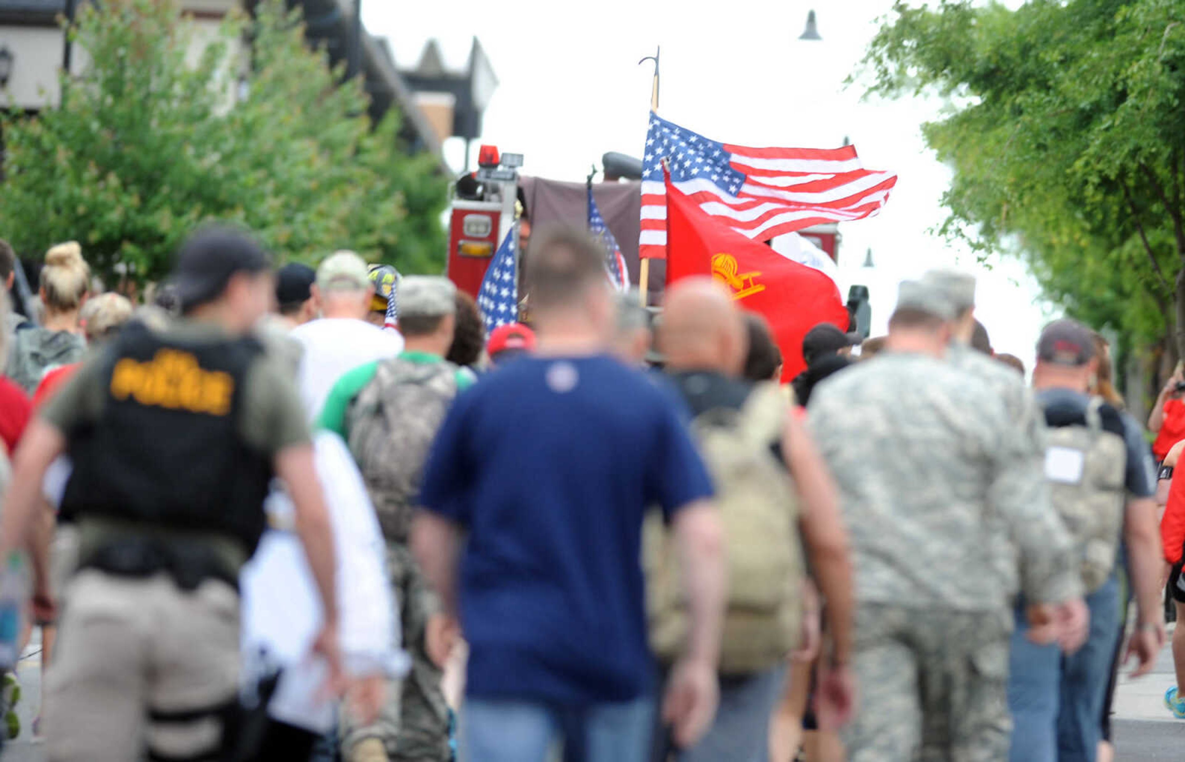 LAURA SIMON ~ lsimon@semissourian.com

Participants in the first ever Carry the Load event are escorted by members of the Cape Girardeau Fire Department as they begin their trek on Broadway, heading to Cape County Park North, Monday, May 25, 2015, in Cape Girardeau.