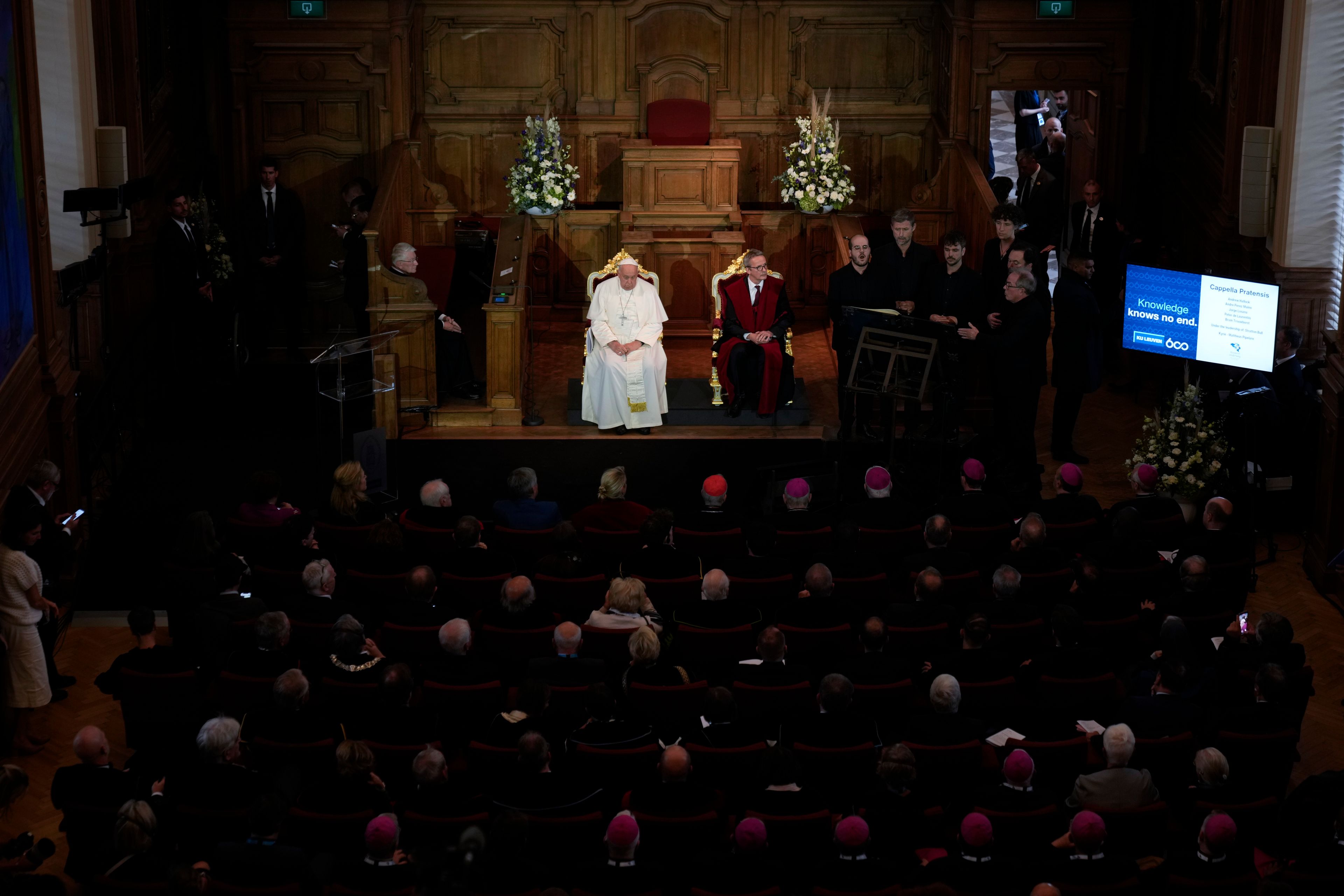 Pope Francis, left, is flanked by Rector Luc Sels during a meeting with the professors in the Promotiezaal of the Catholic University of Leuven, Belgium, Friday, Sept. 27, 2024. (AP Photo/Andrew Medichini)