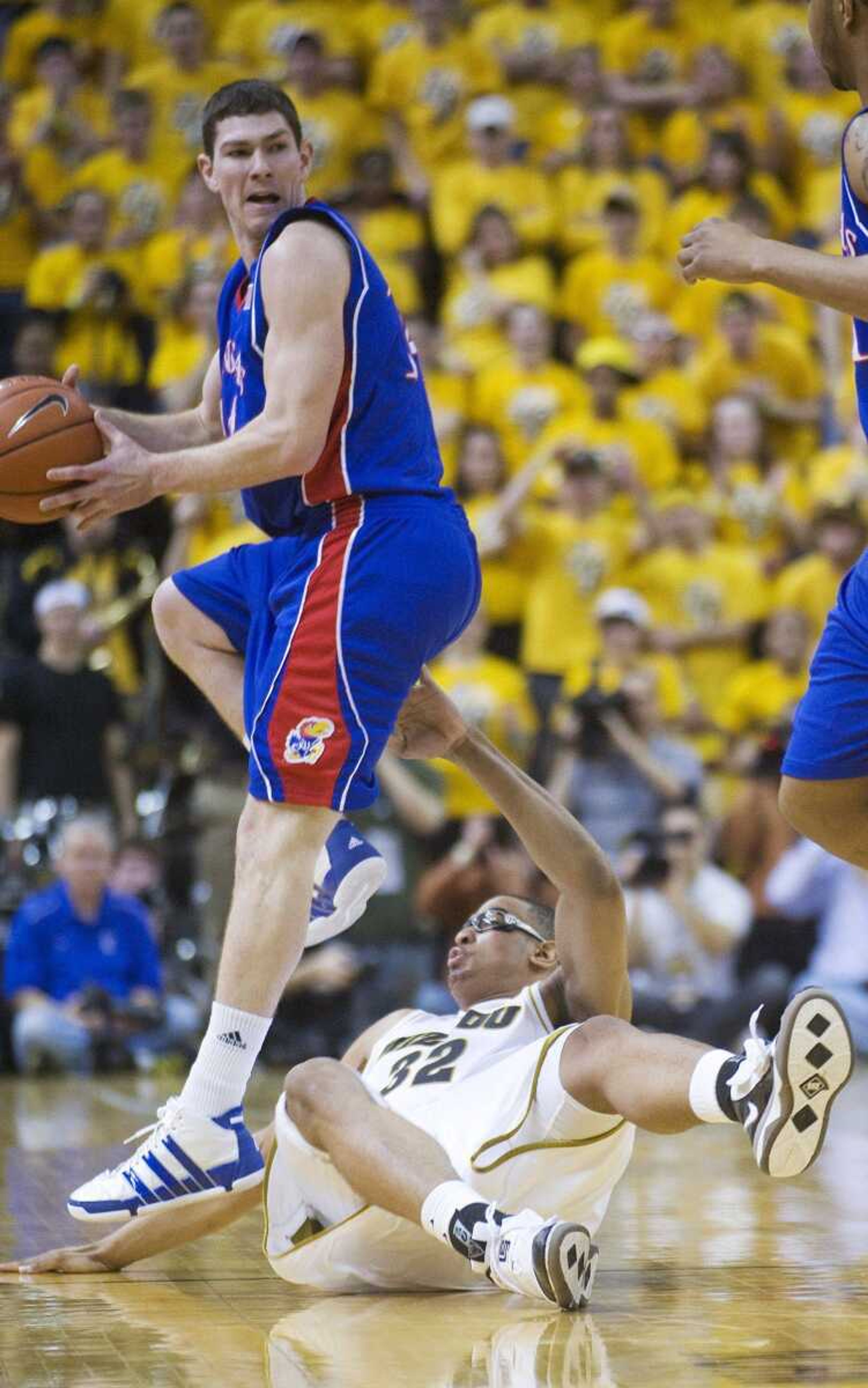 Kansas' Brady Morningstar looks to pass as Missouri's Steve Moore falls to the court during the first half Saturday in Columbia, Mo. (L.G. PATTERSON ~ Associated Press)