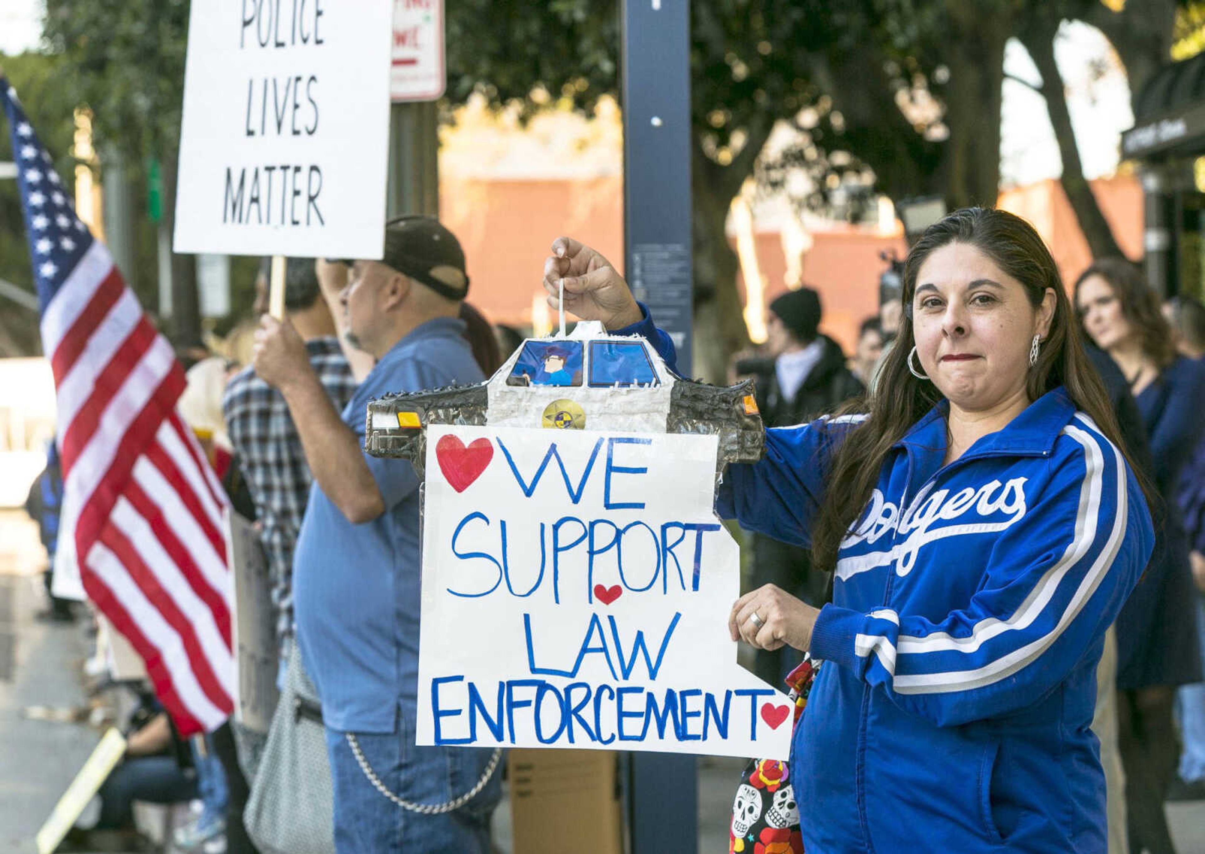 Dawn Mora, whose brother is a Los Angeles police officer, joins demonstrators showing support for law enforcement  across the street from the Los Angeles Police Administrative Building  on Sunday in downtown Los Angeles. (Associated Press)