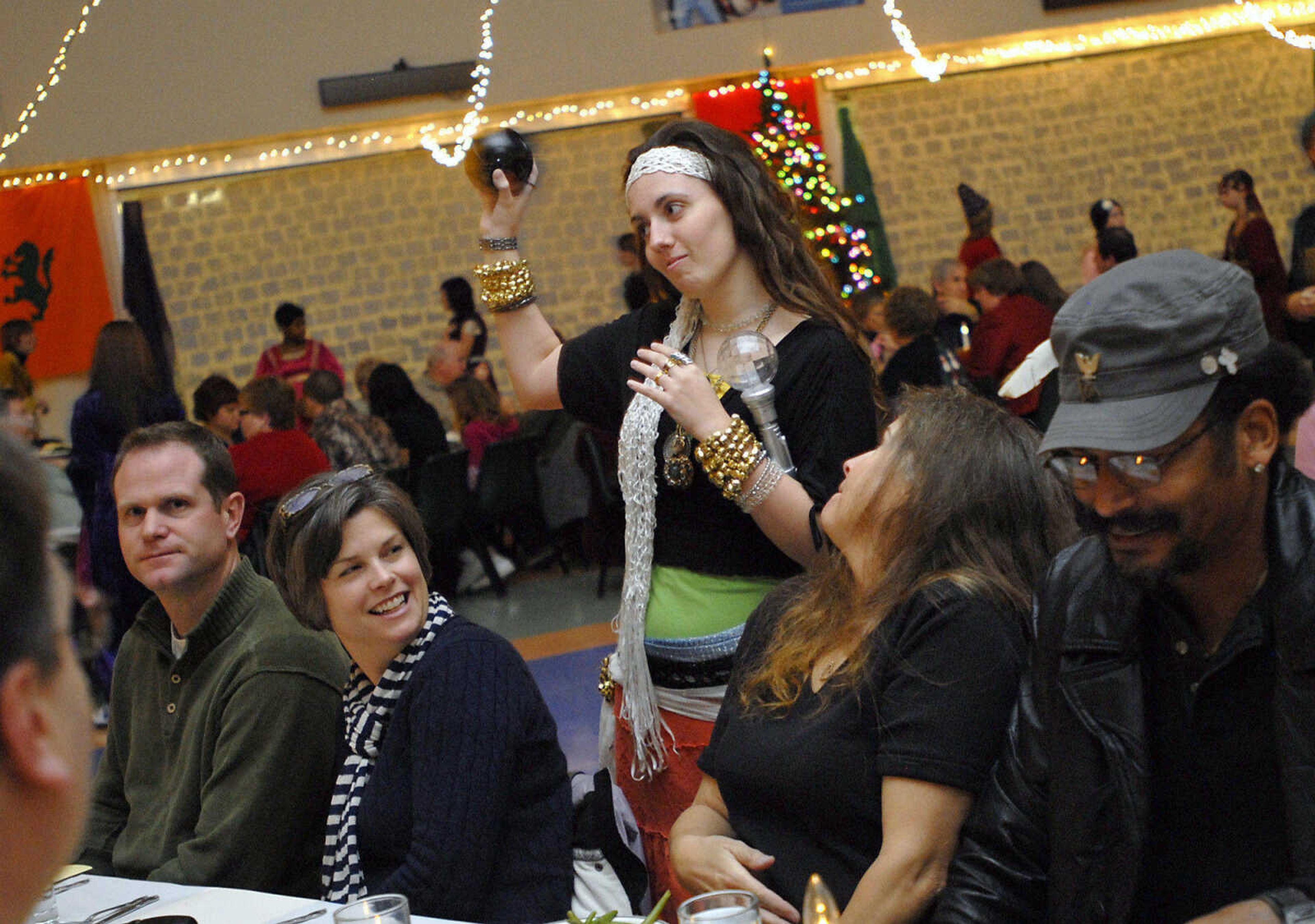 KRISTIN EBERTS ~ keberts@semissourian.com

Fortune Teller Megan Mitchell uses a Magic 8 Ball to predict the future for a group of guests during the Central High School Choral Department's "Ye Olde Yuletide Madrigal Feaste," on Friday, Dec. 10, 2010, in Cape Girardeau. Students provided singing, food and entertainment as they transported guests back to Christmas in Renaissance England.