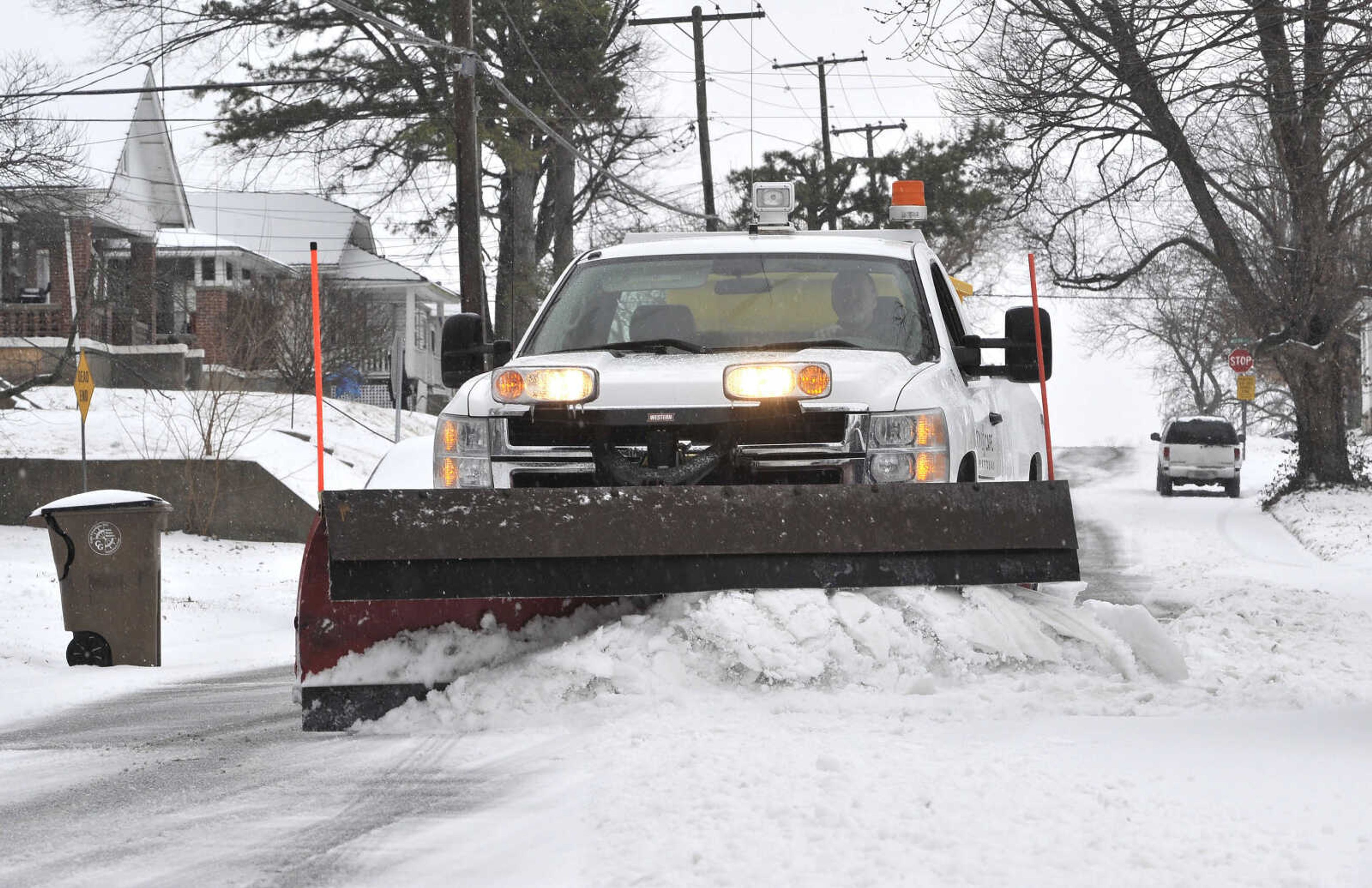 A city snow plow clears a path in the 1300 block of Jefferson Avenue Sunday morning, Feb. 14, 2016 in Cape Girardeau.