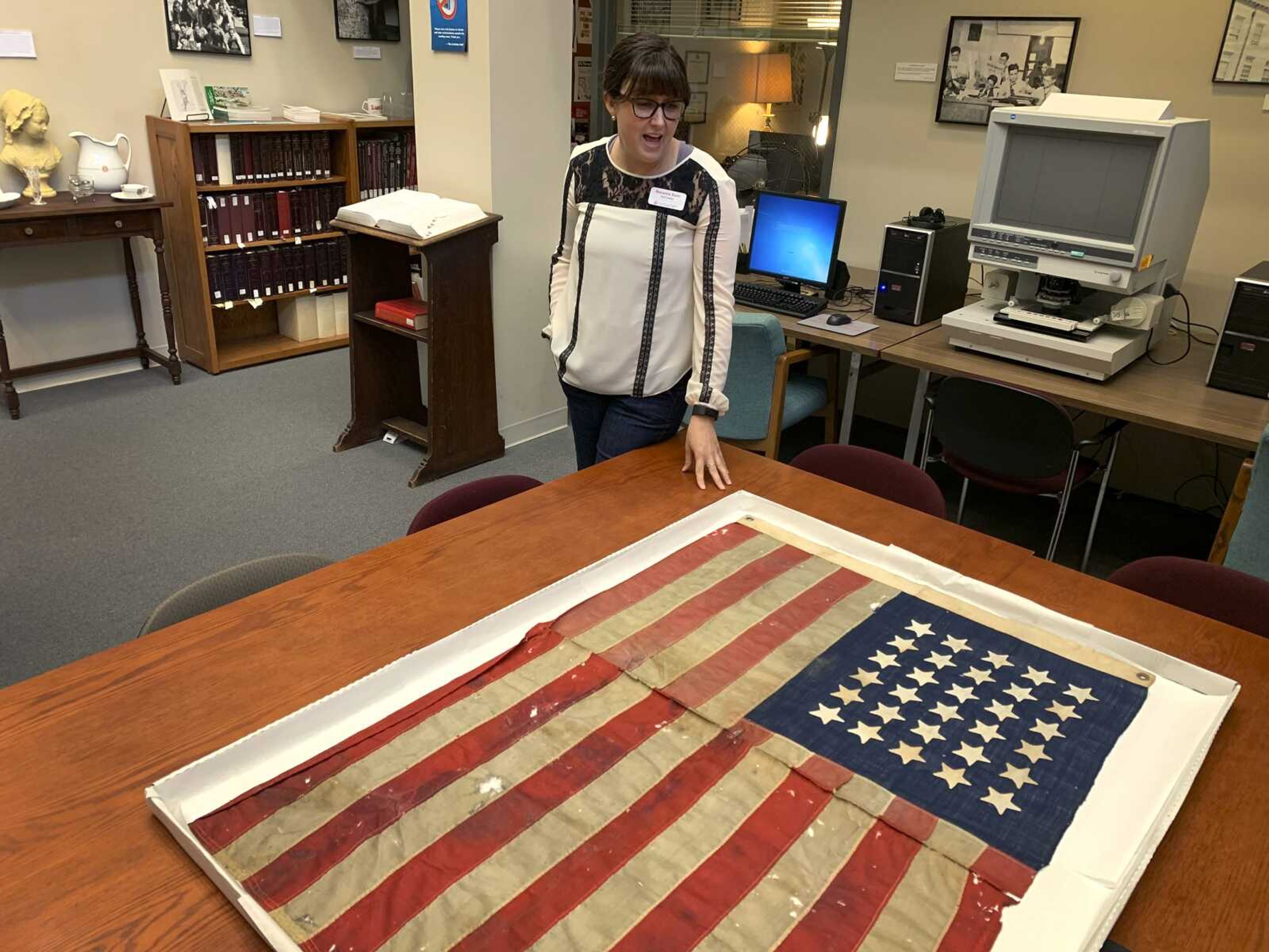 Southeast Missouri State University Special Collections and Archives librarian Roxanne Dunn talks Tuesday about acquiring a 171-year-old 30-star American flag donated by George Ann Huck at Southeast's Kent Library in Cape Girardeau.