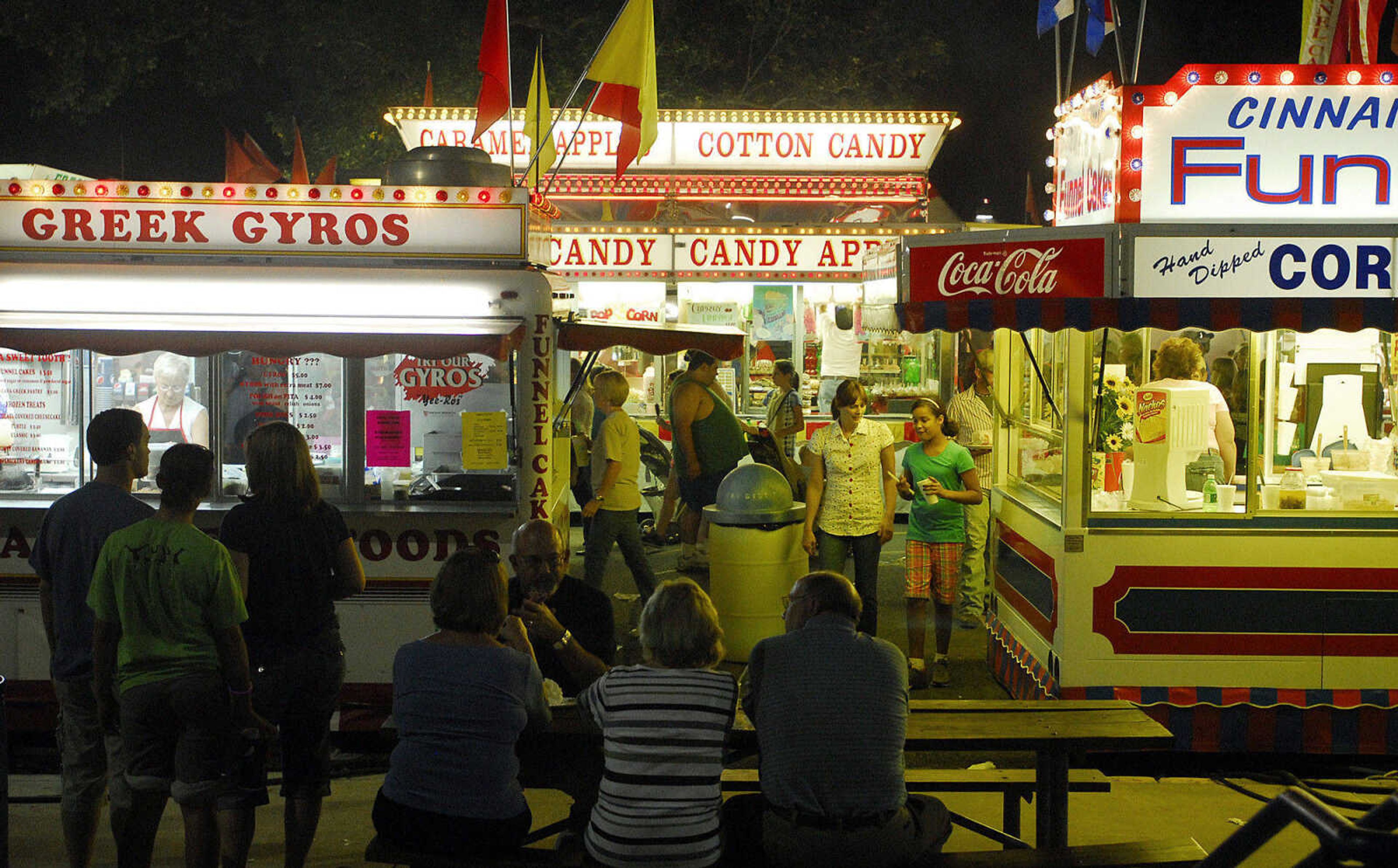 LAURA SIMON~lsimon@semissourian.com
People sit and walk to eat their fair food Thursday, September 16, 2010 during the 155th Annual SEMO District Fair.