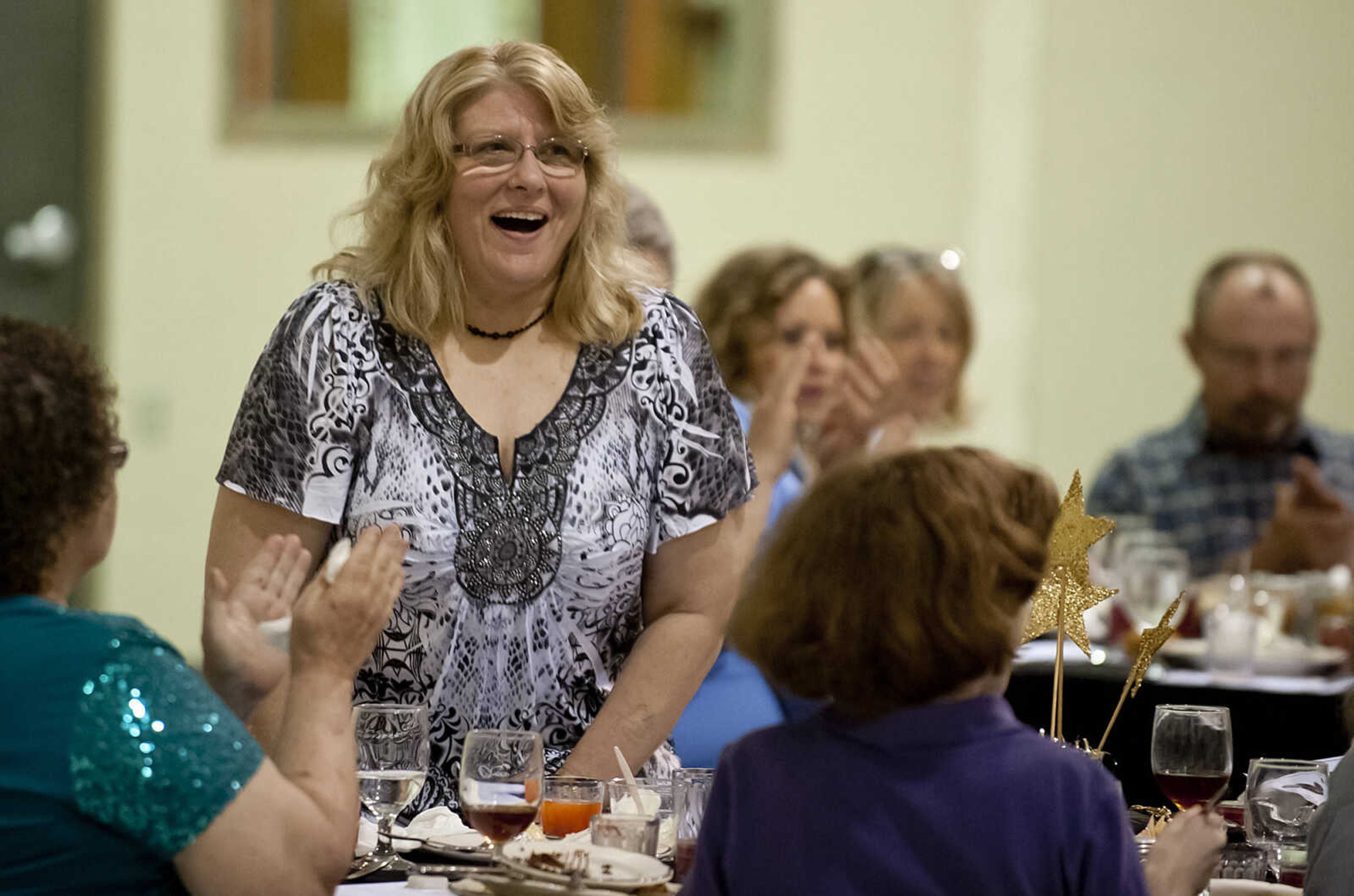 Case worker Tina Rodgers reacts after being named the recipient of the Star Light Award during the Cape Girardeau Salvation Army's annual dinner, "A Night with the Stars," Thursday, May 8, at the Cape Girardeau Salvation Army.