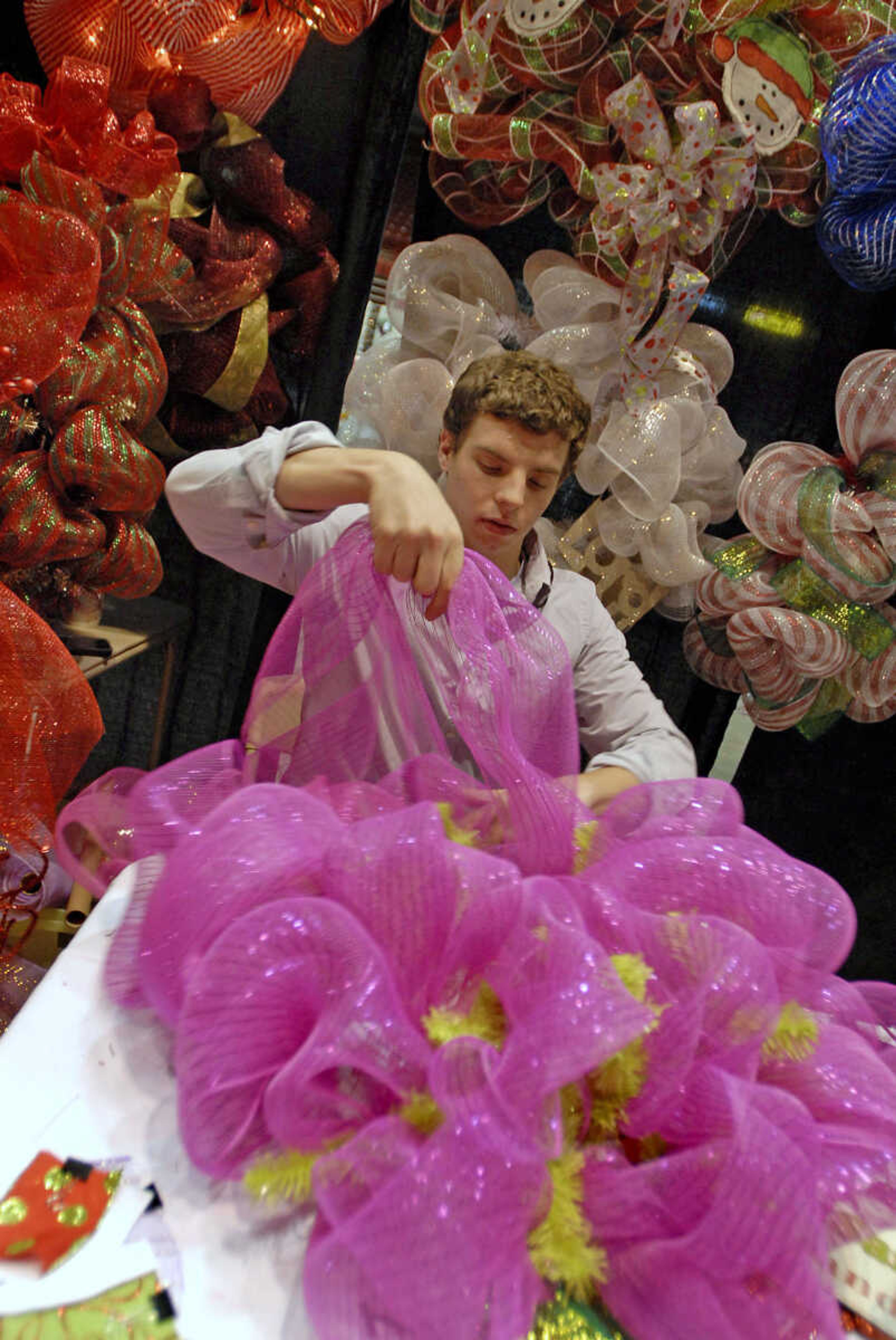 KRISTIN EBERTS ~ keberts@semissourian.com

Clint Klipfel, of "Florassentials" creates a wreath during the Arts and Crafts Extravaganza at the Show Me Center in Cape Girardeau on Saturday, Nov. 19, 2011.