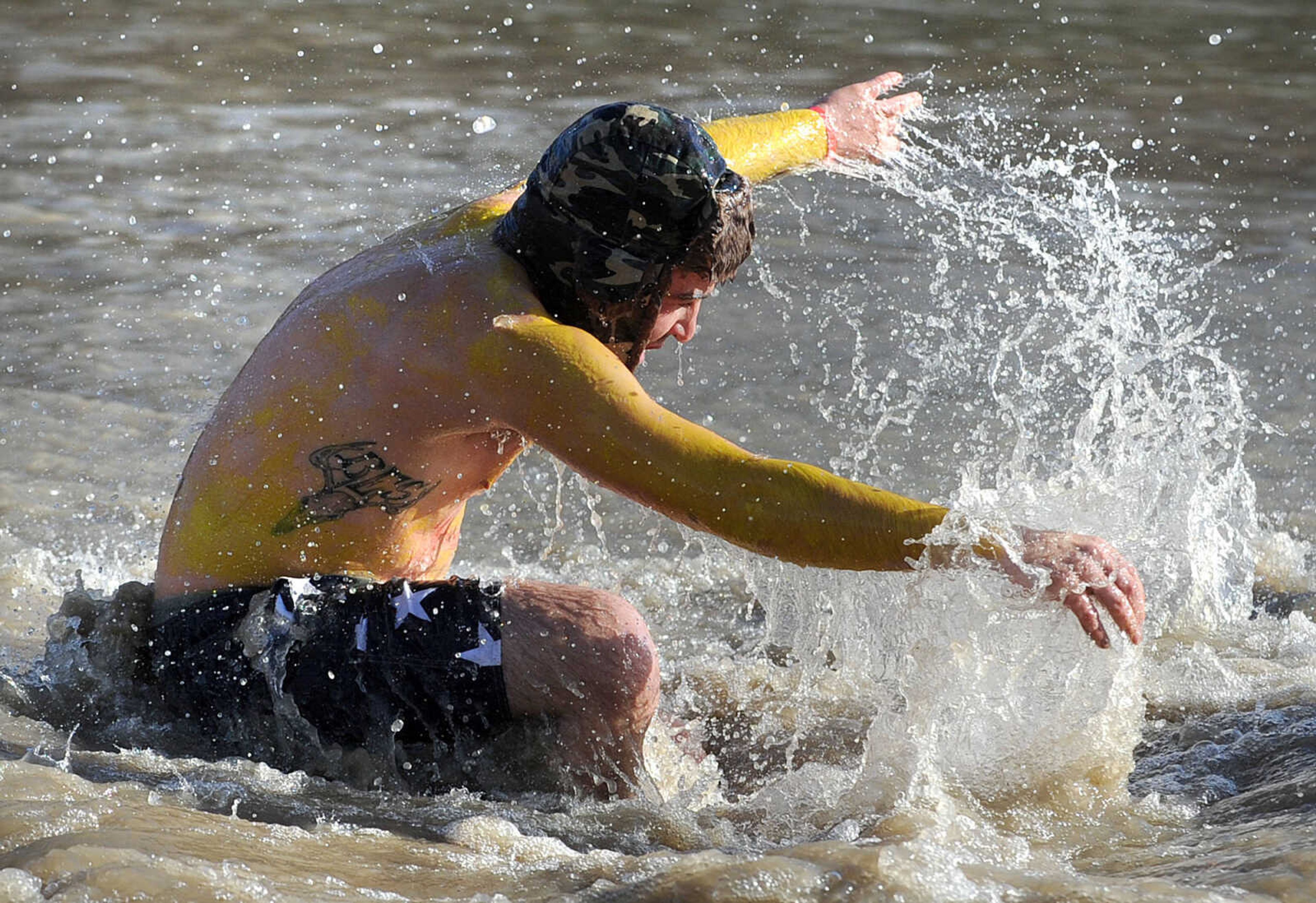 LAURA SIMON ~ lsimon@semissourian.com
People plunge into the cold waters of Lake Boutin Saturday afternoon, Feb. 2, 2013 during the Polar Plunge at Trail of Tears State Park. Thirty-six teams totaling 291 people took the annual plunge that benefits Special Olympics Missouri.