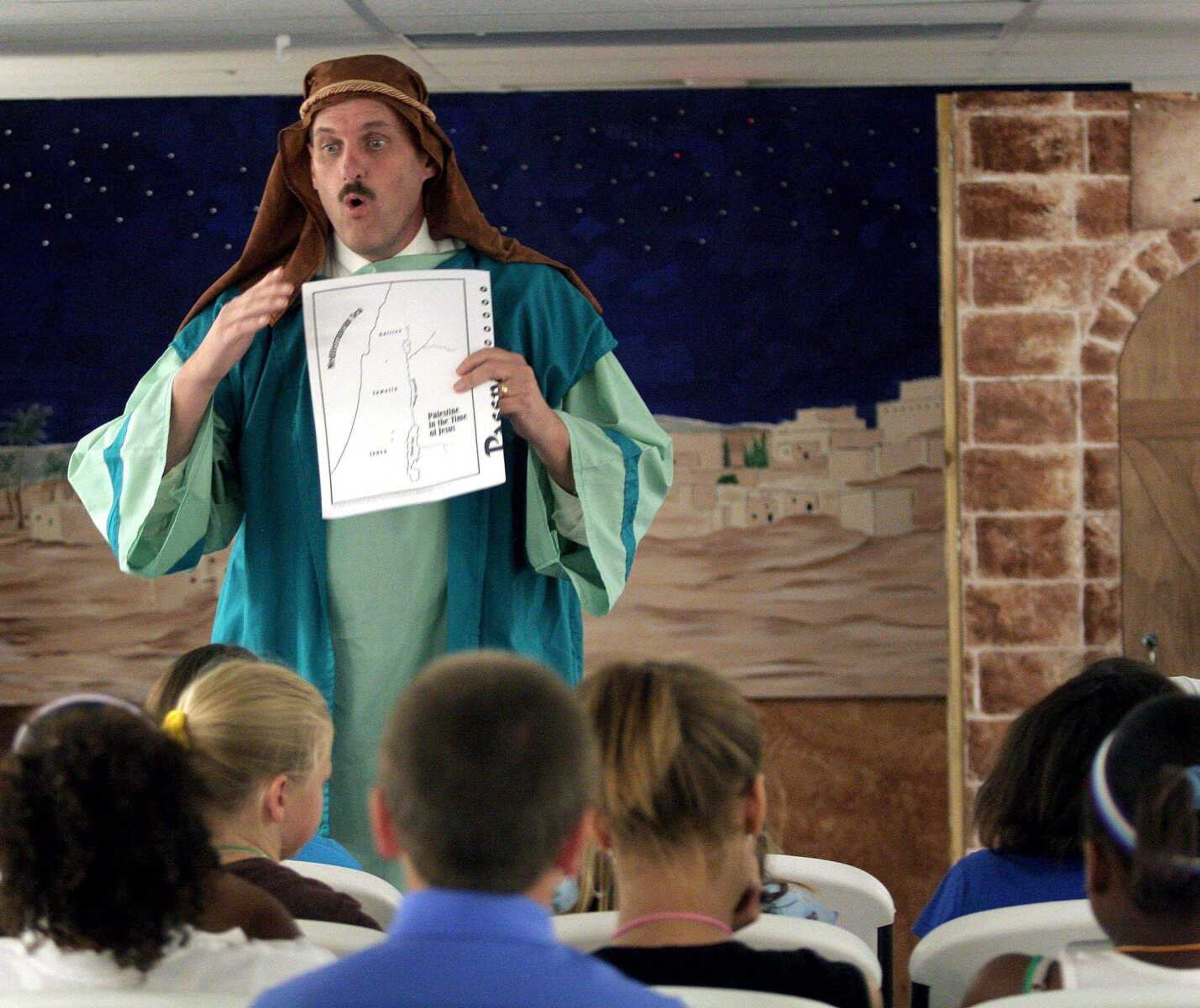 Rick Doan teaches 8-to-13-year-olds about Jesus by telling the story of a man who witnessed Jesus heal his daughter. The class was held during a vacation Bible school called "Going to the Promised Land" Thursday at Lighthouse Baptist Church in Cape Girardeau. Another vacation Bible school in Cape Girardeau recentlyhad a Roman marketplace theme. (Elizabeth Dodd)