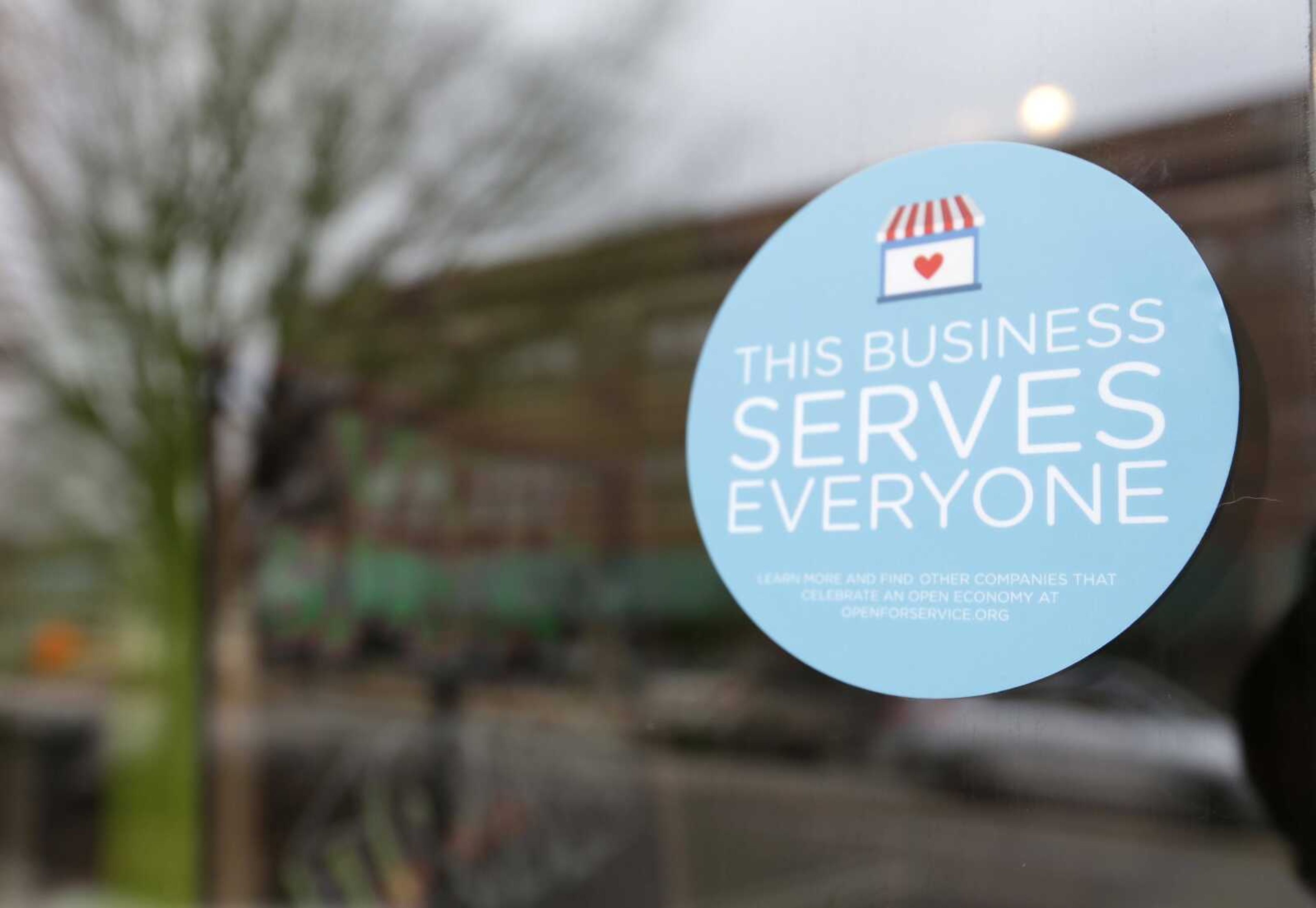 A window sticker promising service to all is displayed March 25 in downtown Indianapolis in opposition to the state new religious-objections law. (Michael Conroy ~ Associated Press)