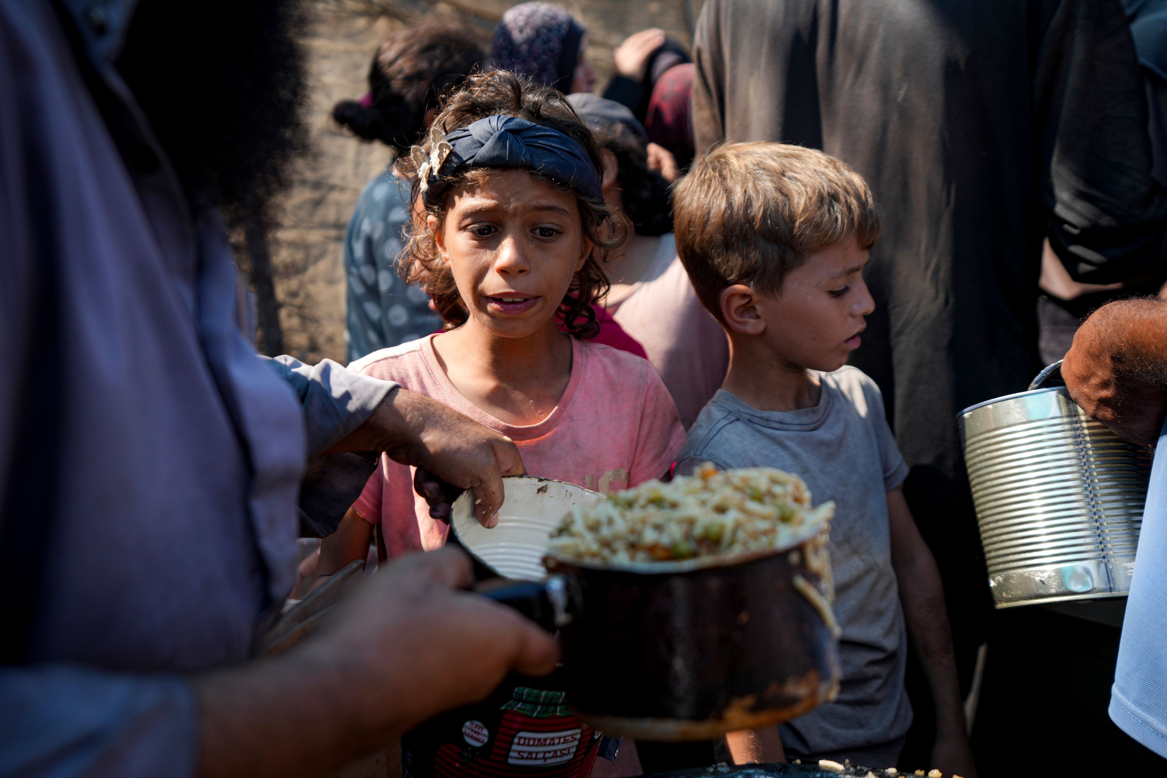 FILE - Palestinians line up for food distribution in Deir al-Balah, Gaza Strip, Thursday, Oct. 17, 2024. (AP Photo/Abdel Kareem Hana, File)